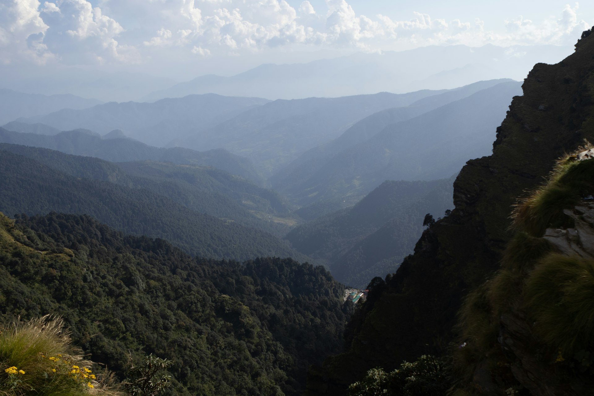 A view of a valley with mountains in the background