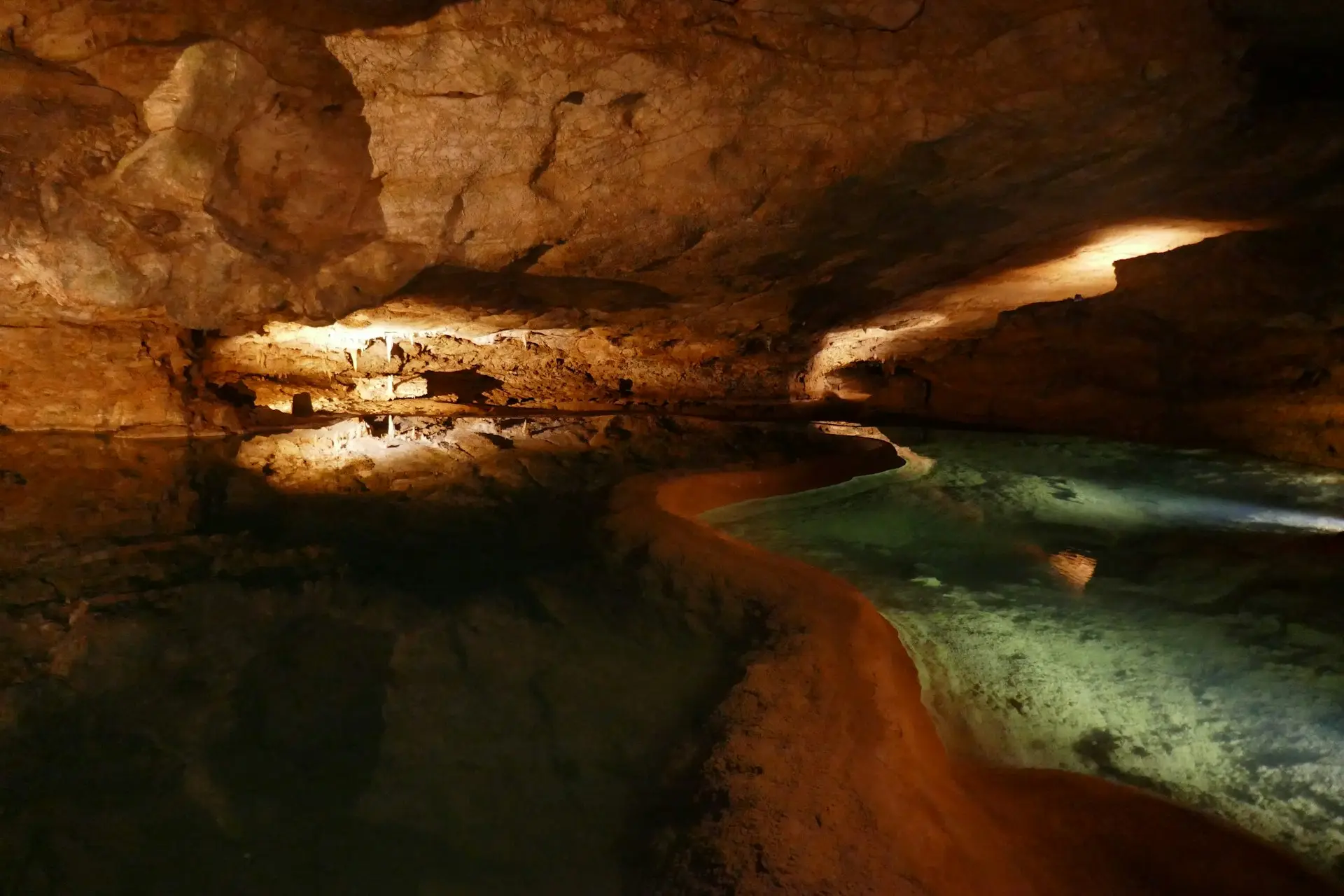 A beautiful cave with a sparkling river.