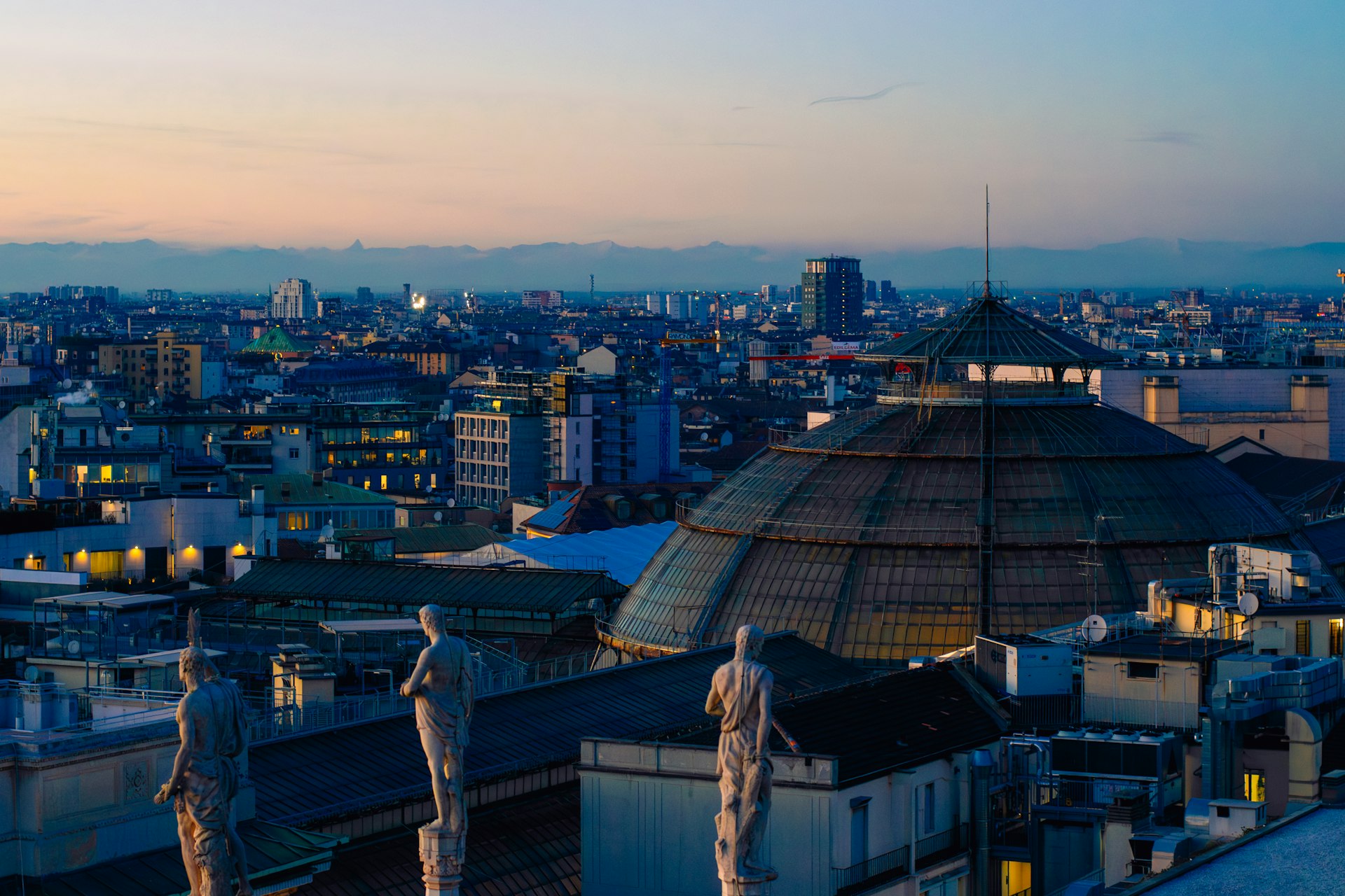 a view of a city at dusk from a rooftop