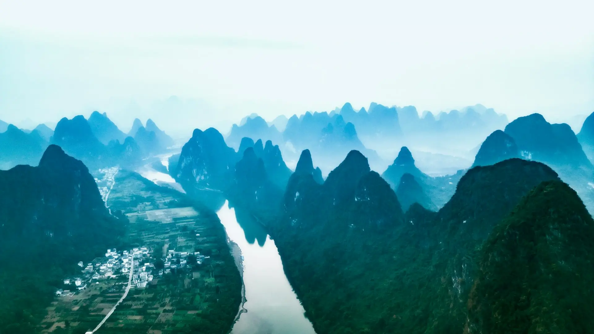 an aerial view of a river surrounded by mountains