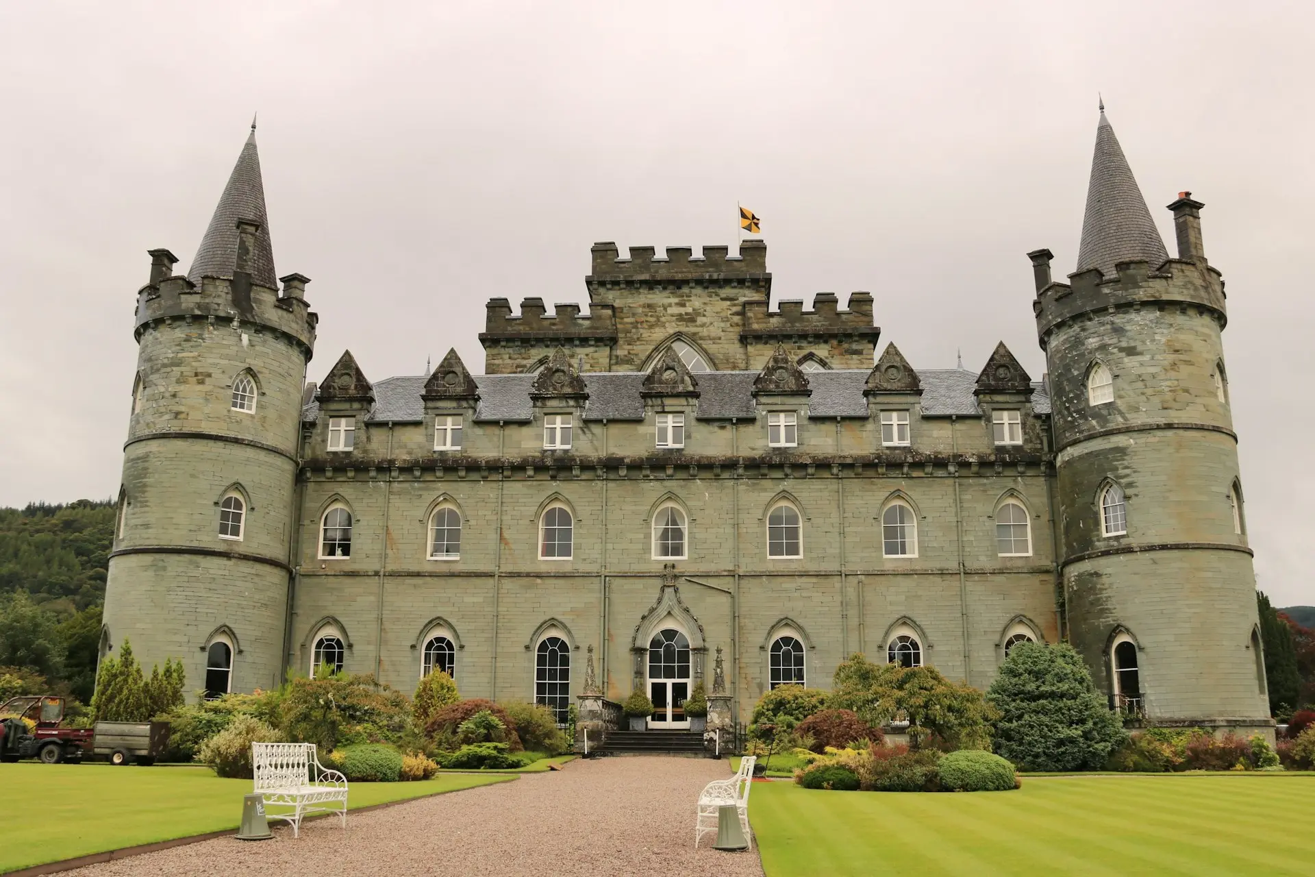 a large castle like building sitting on top of a lush green field
