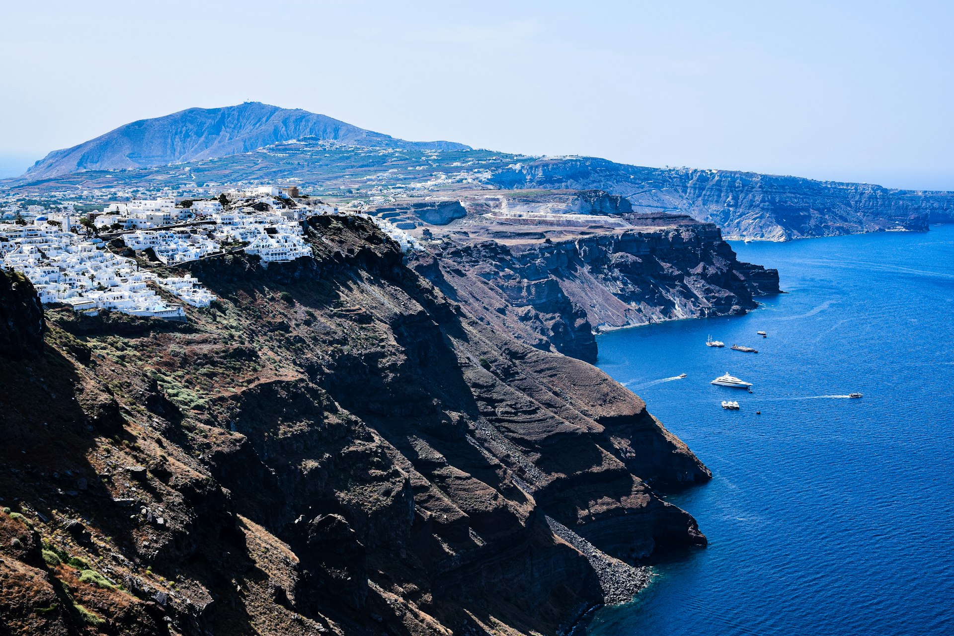a rocky cliff next to a body of water