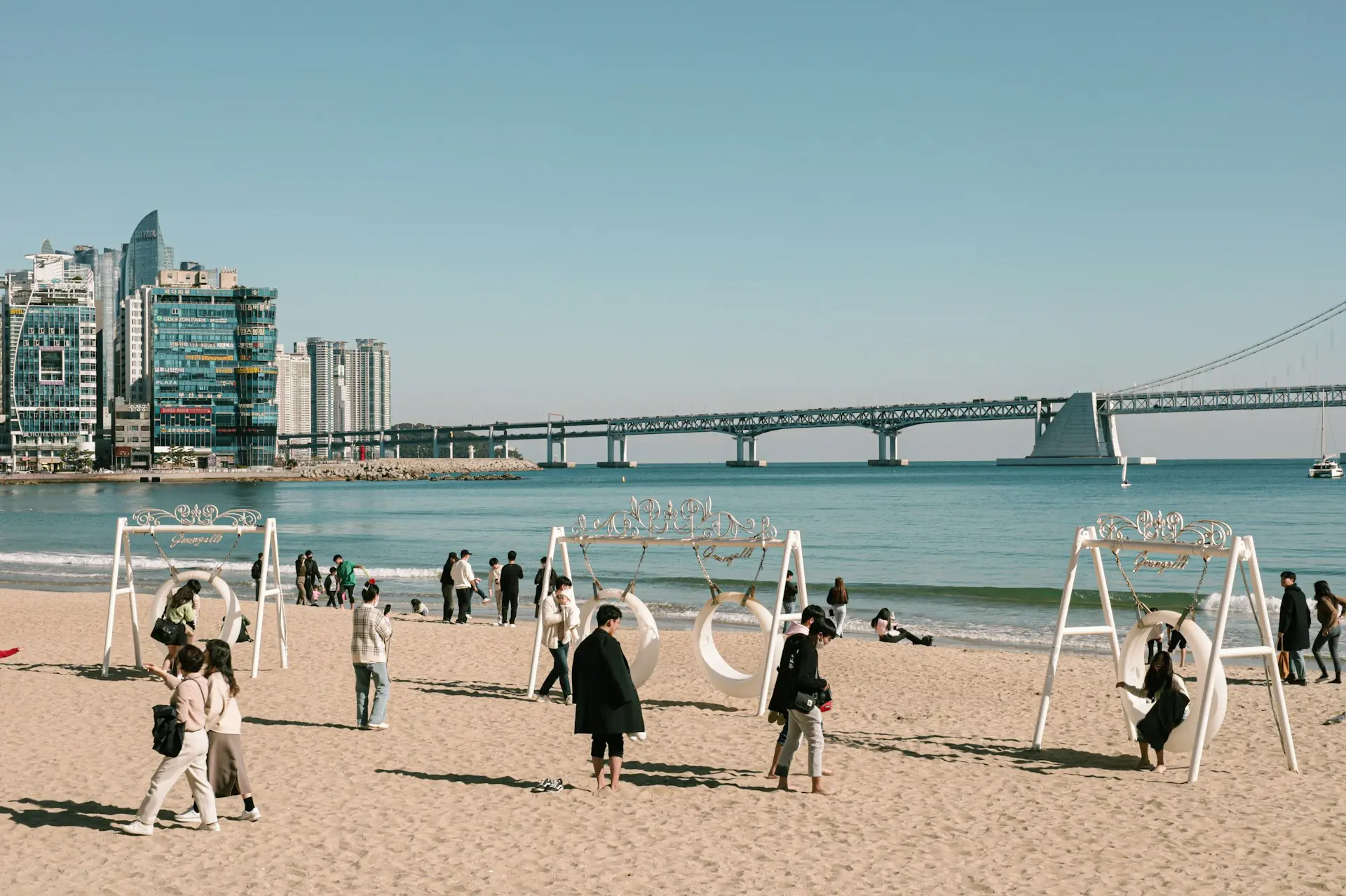 a group of people standing on top of a sandy beach