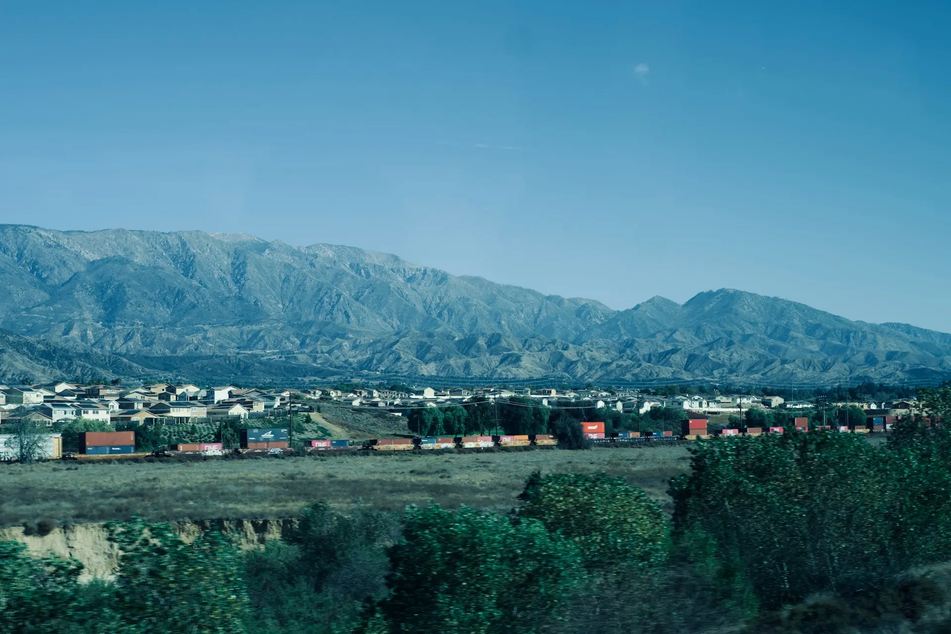a view of a city with mountains in the background