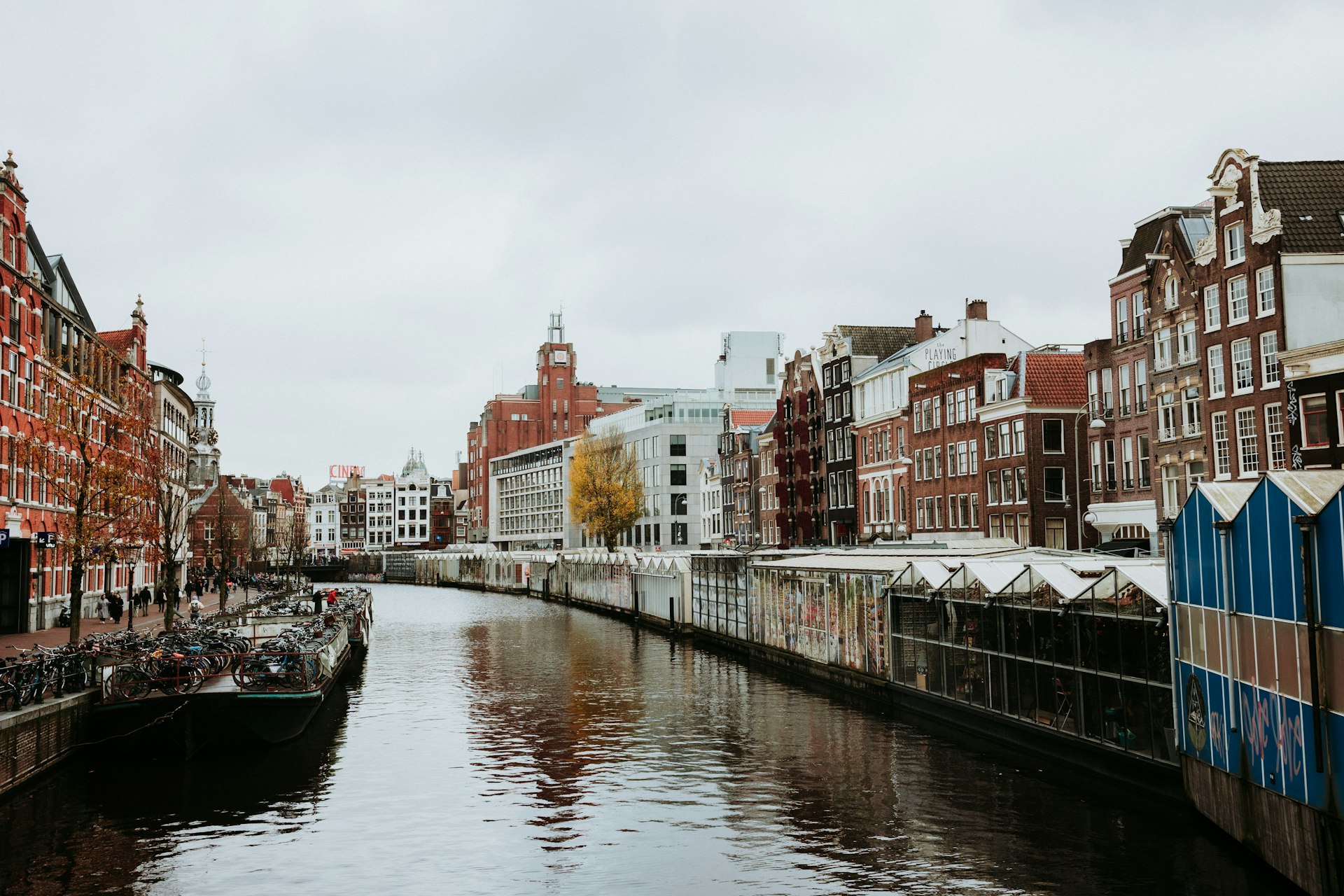 Canal lined with buildings on a cloudy day.