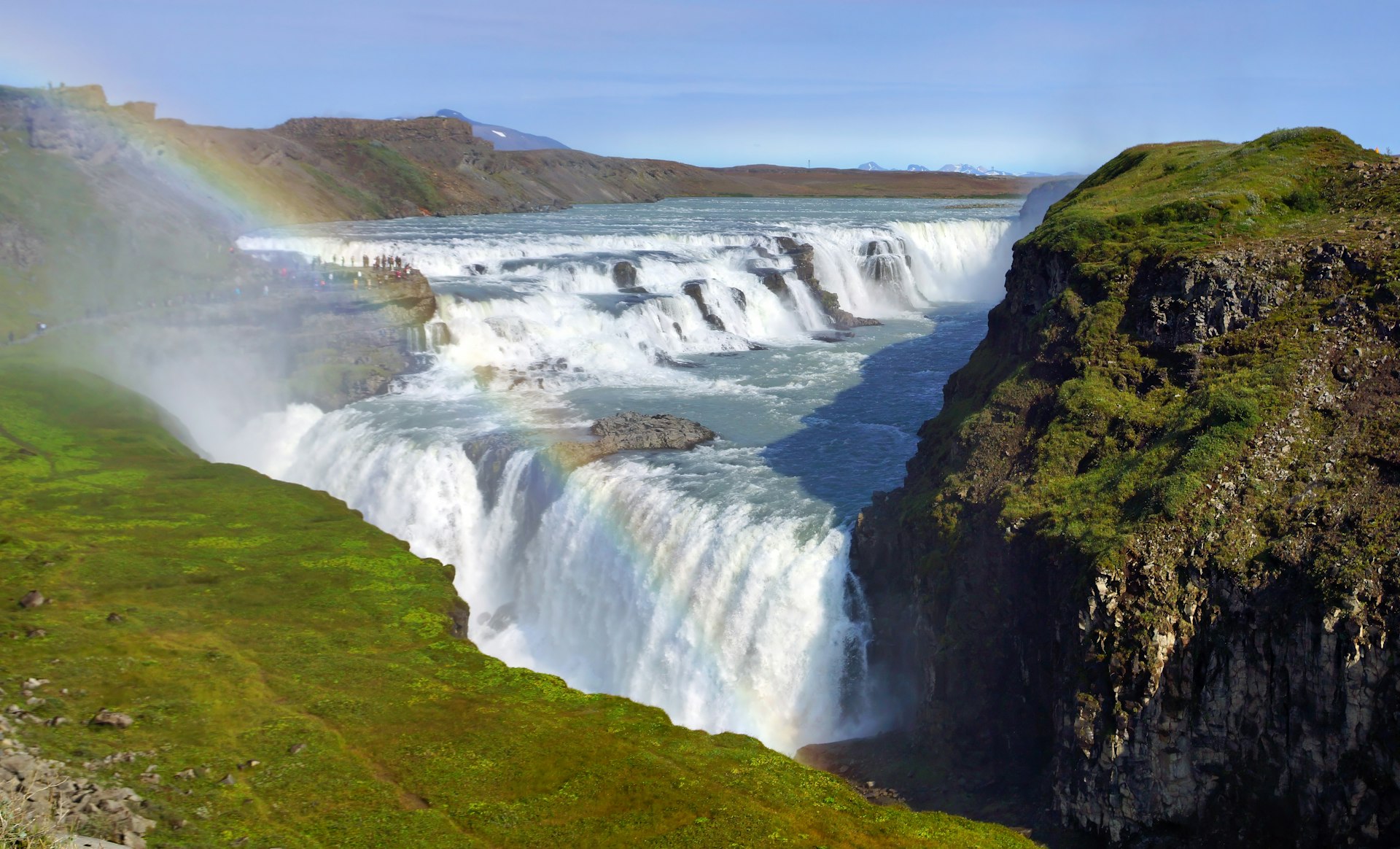 a waterfall with a rainbow in the middle of it