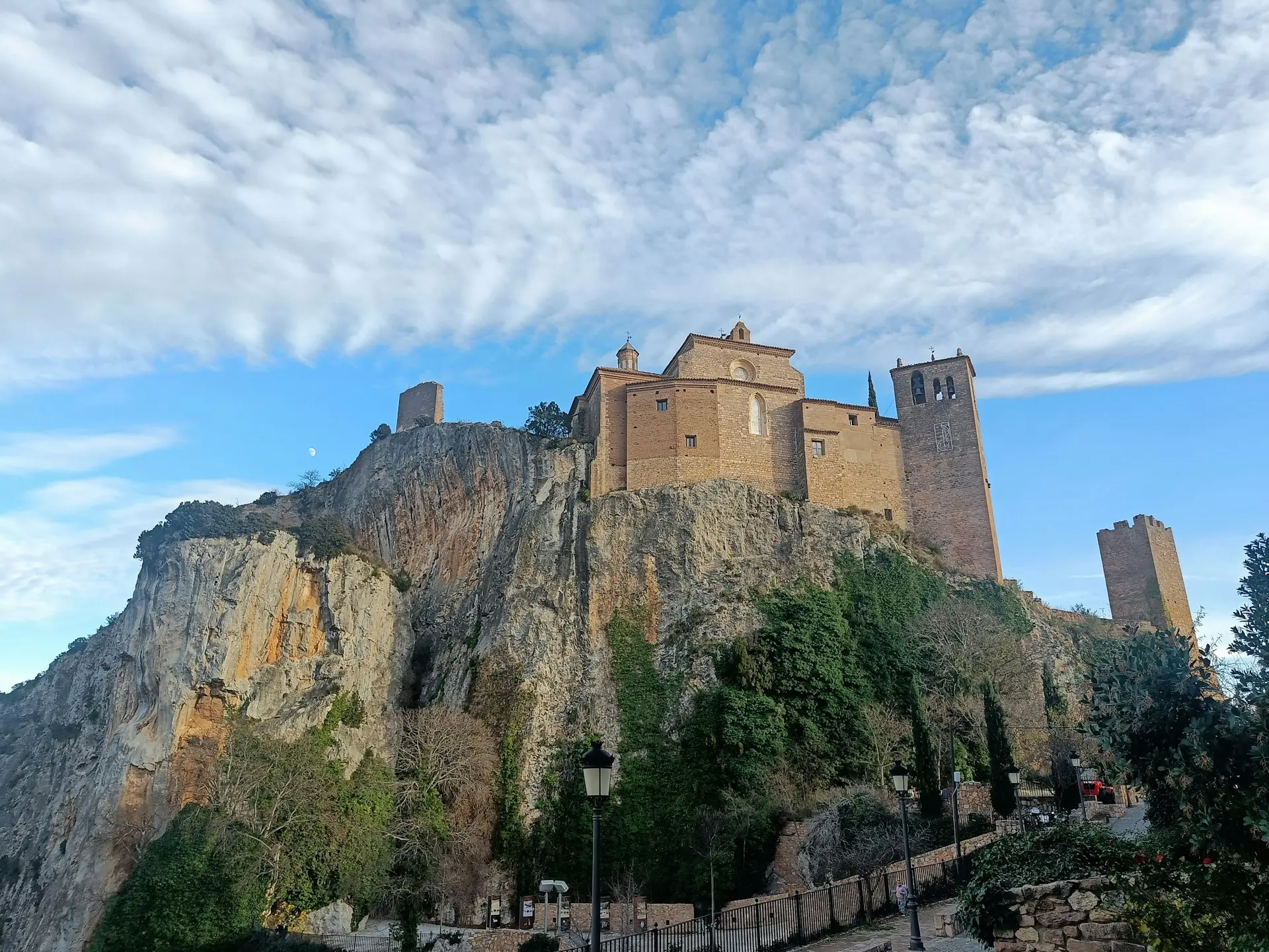 a castle on top of a mountain with a sky background