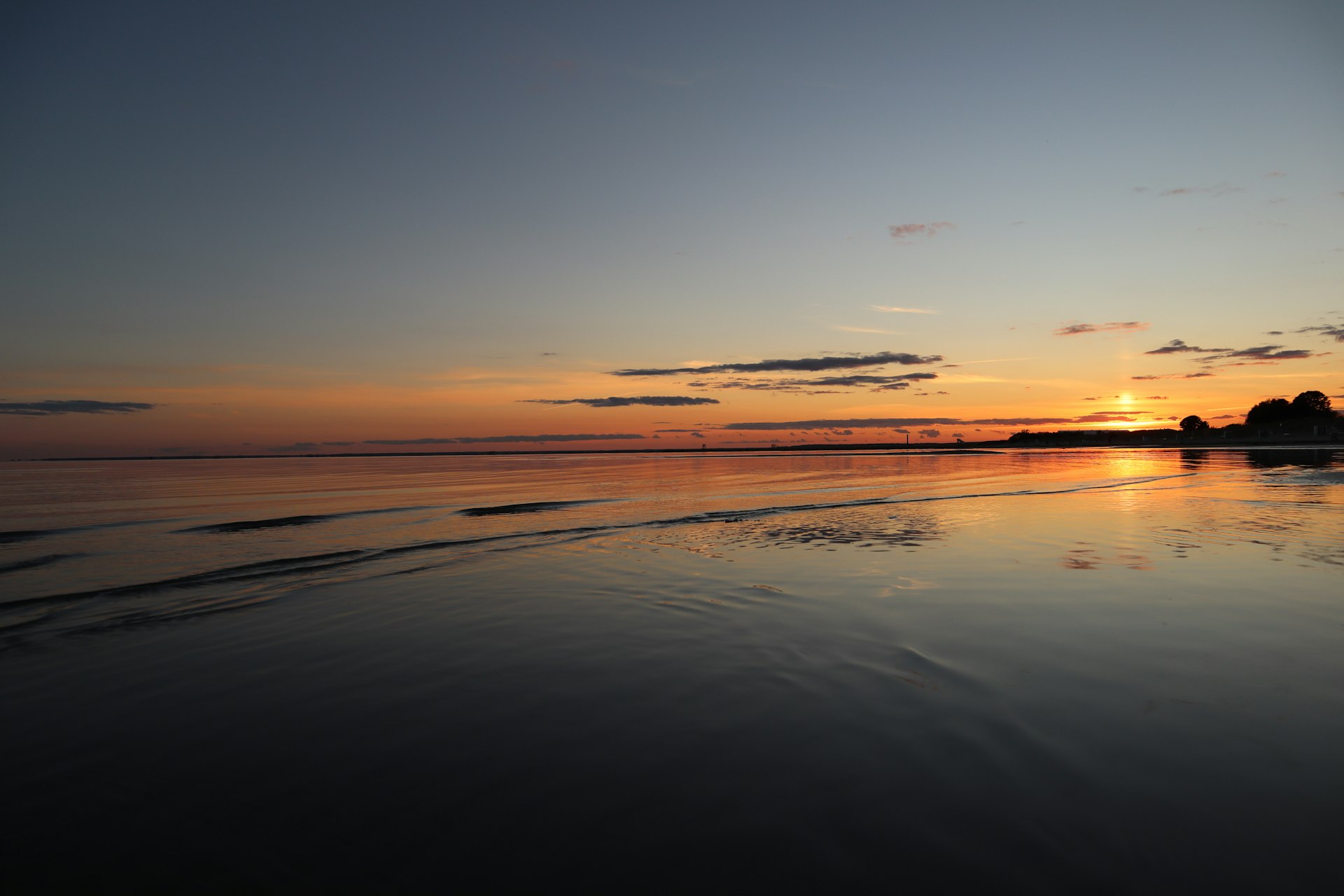 body of water during sunset
