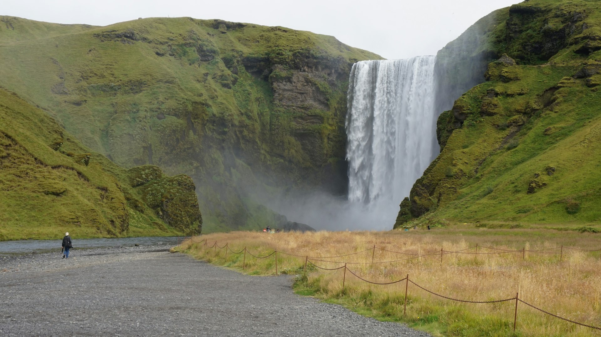 waterfalls on brown and green mountain during daytime