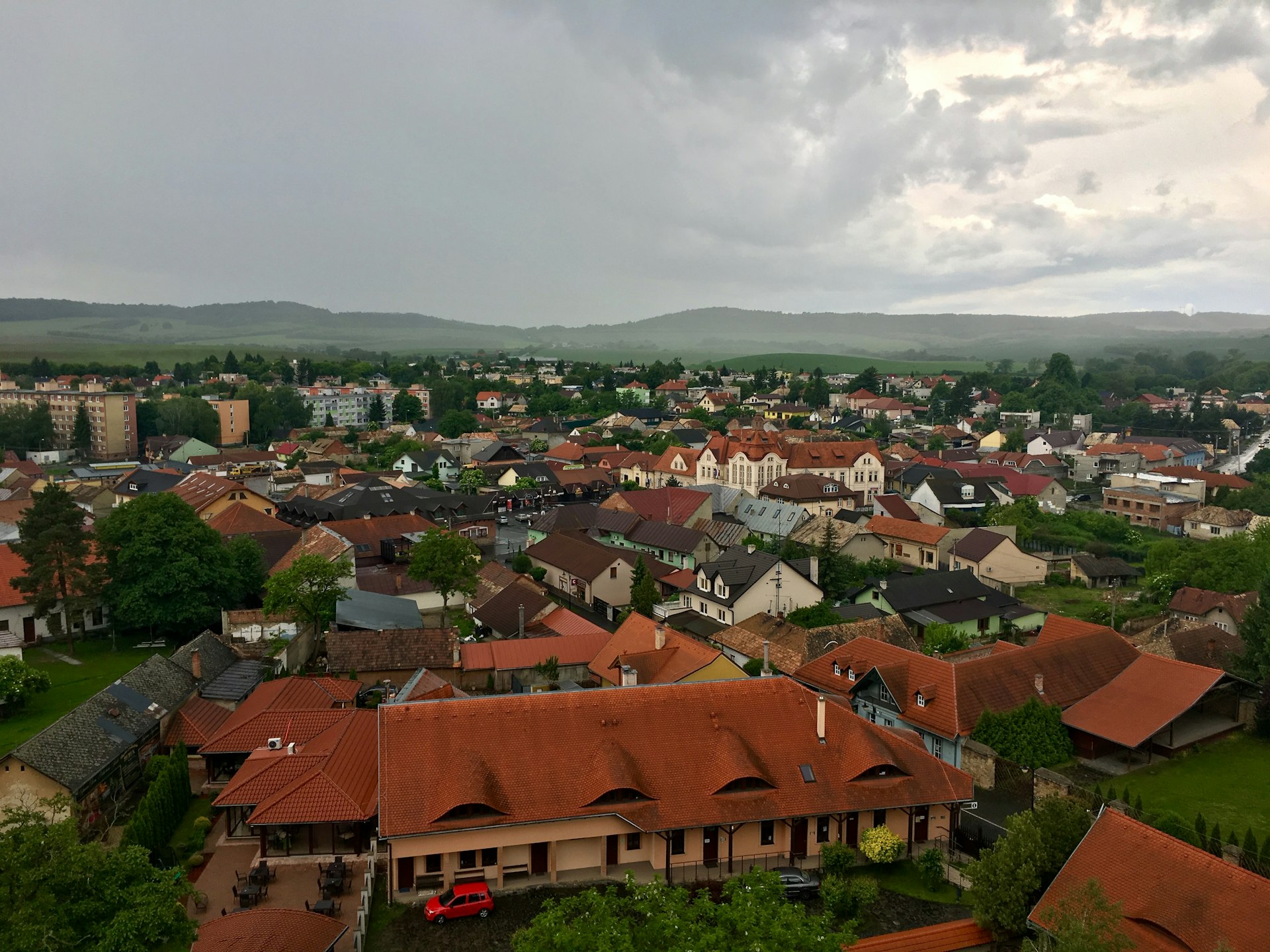 an aerial view of a city with red roofs