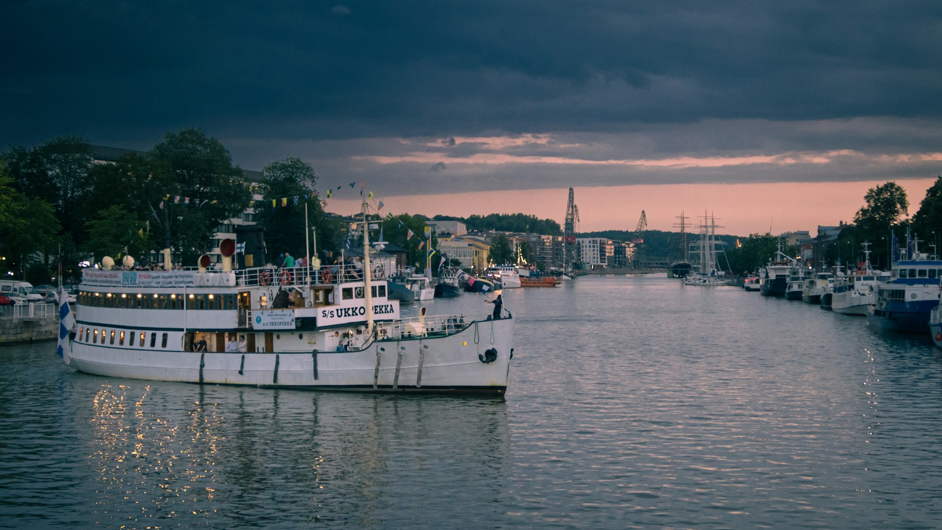 A harbor filled with lots of boats under a cloudy sky