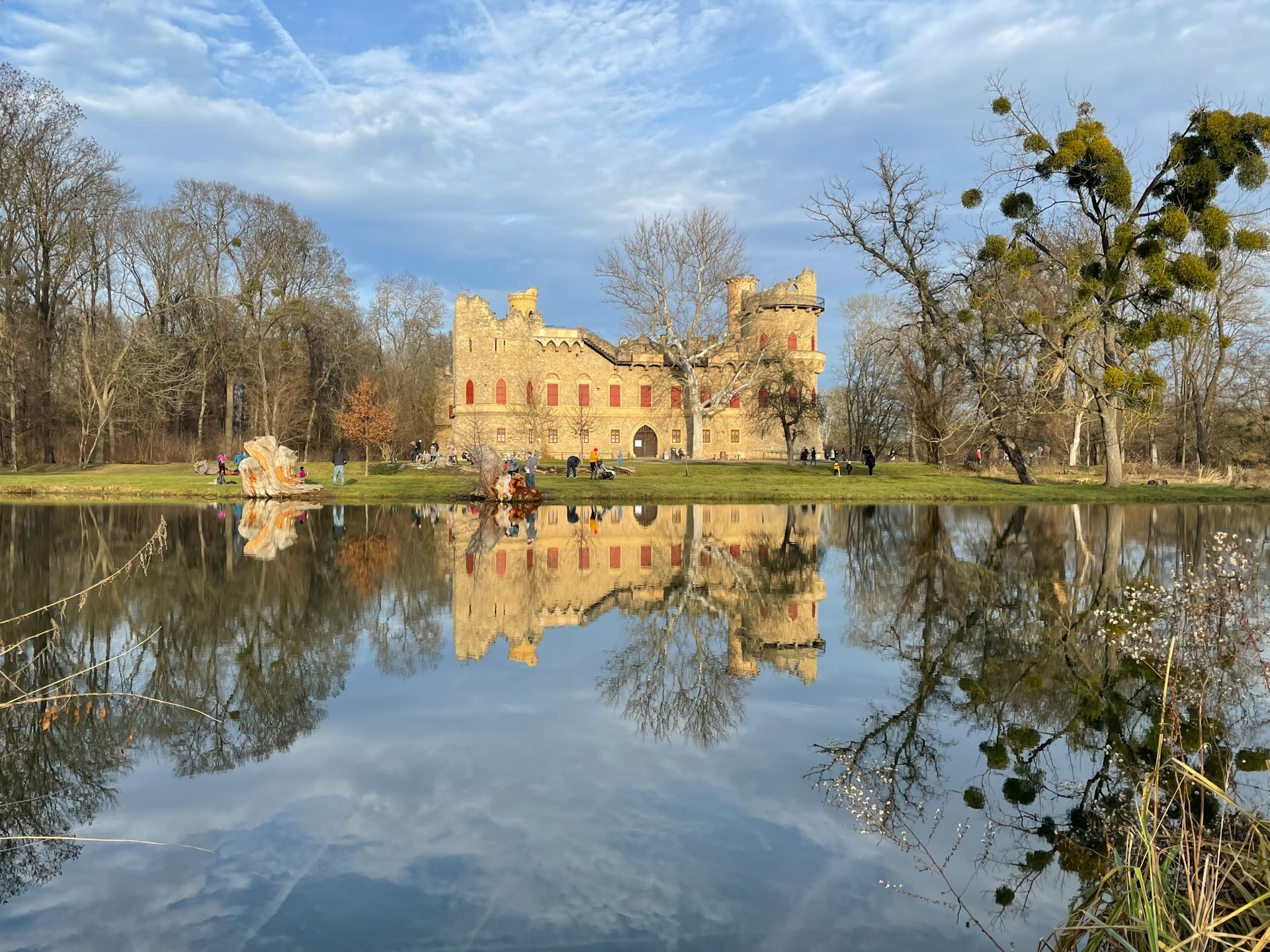 a large castle sitting on top of a lush green field