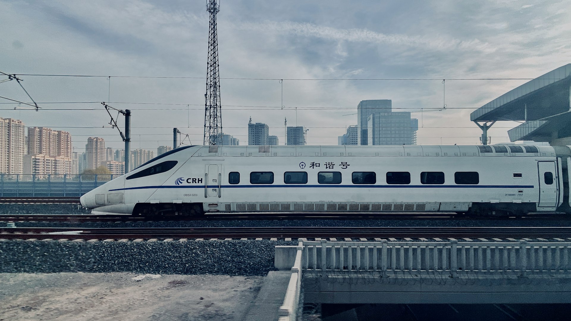 white and blue train on rail during daytime