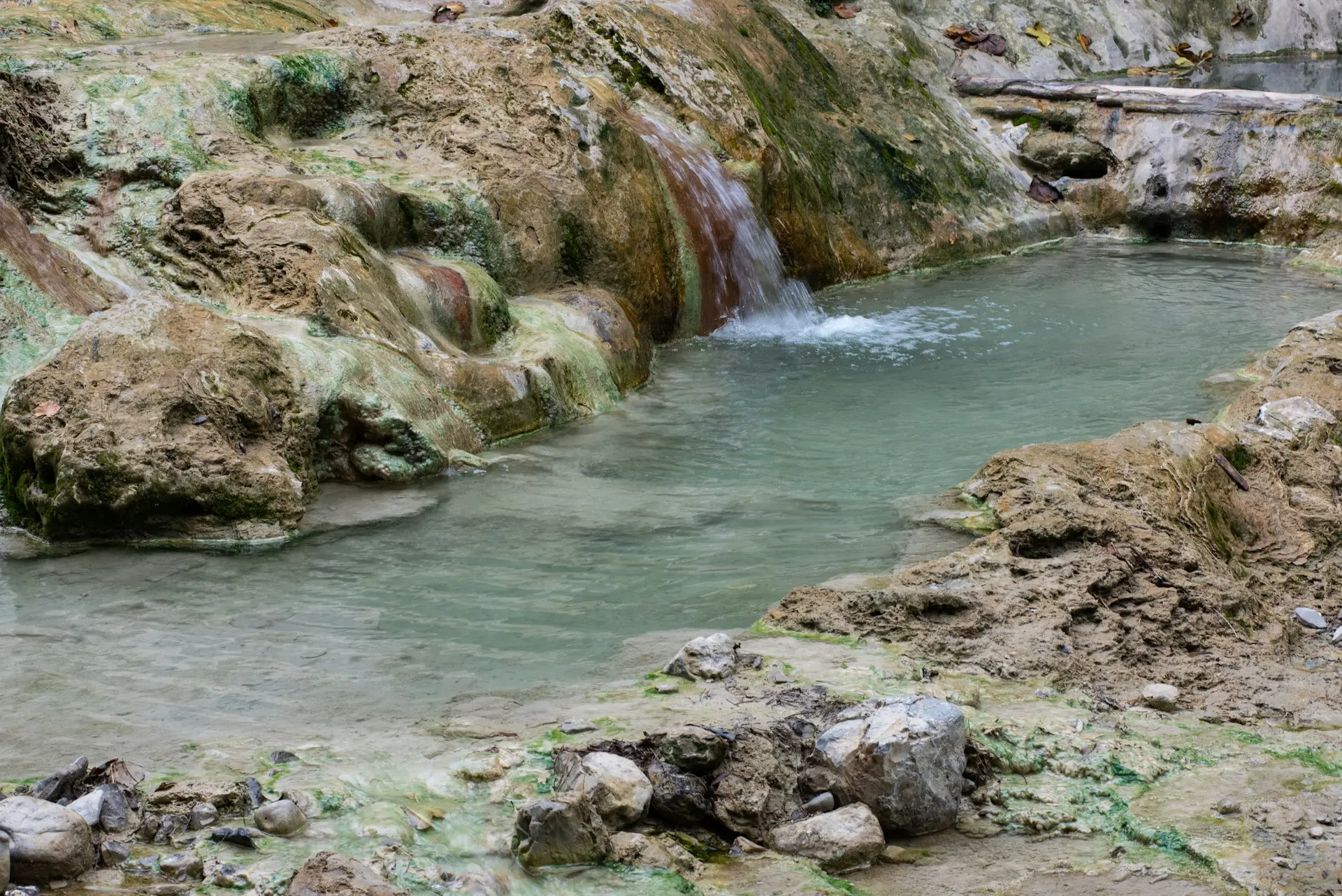 A small pool of water surrounded by rocks