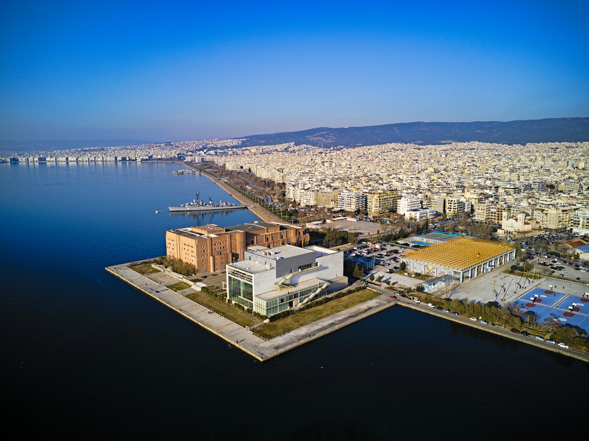 a large body of water with a city in the background