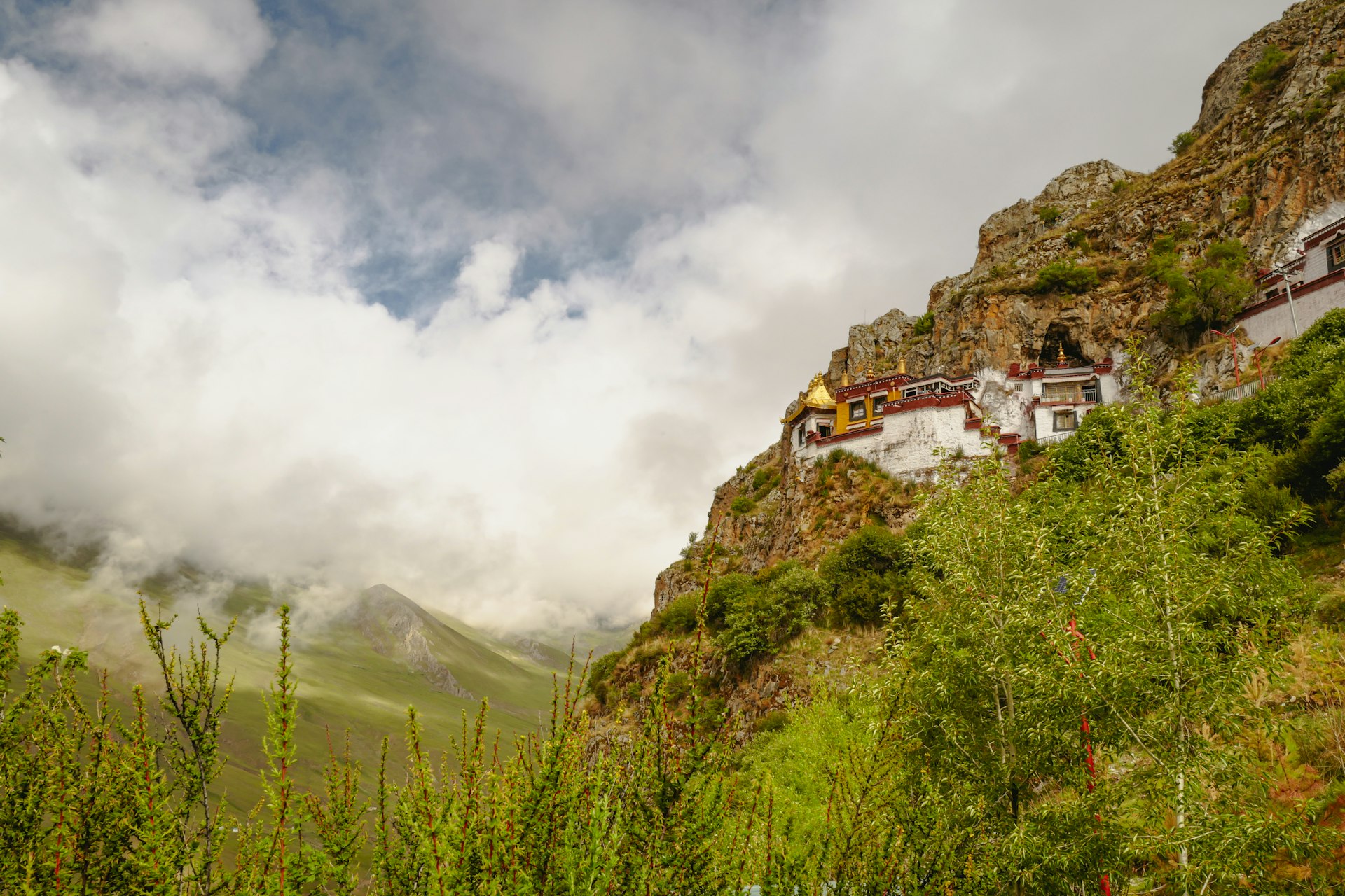 white and brown concrete building on top of mountain