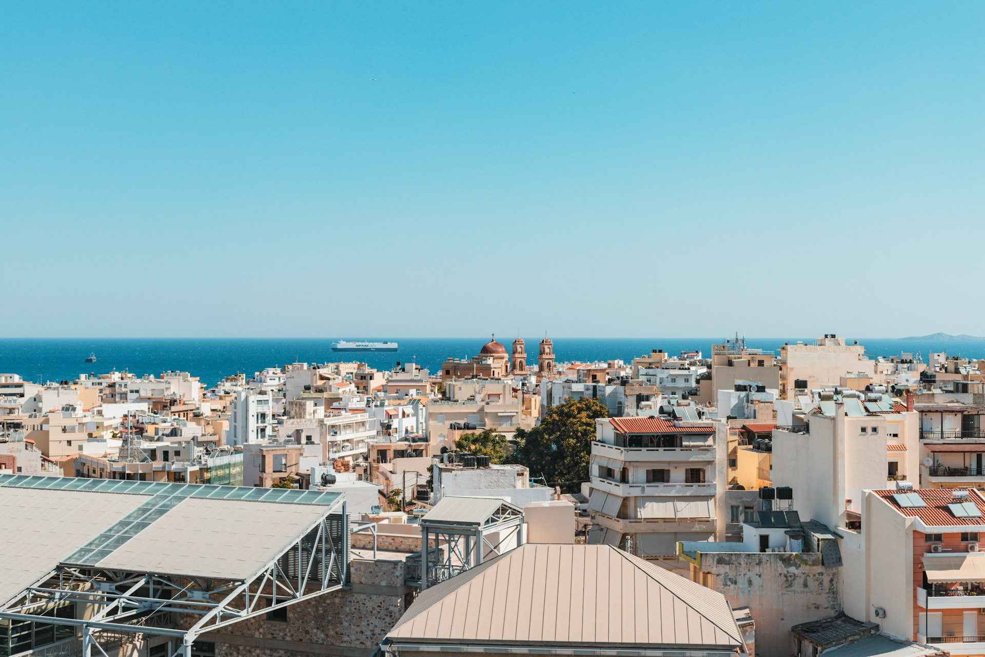a city with many buildings and water in the background
