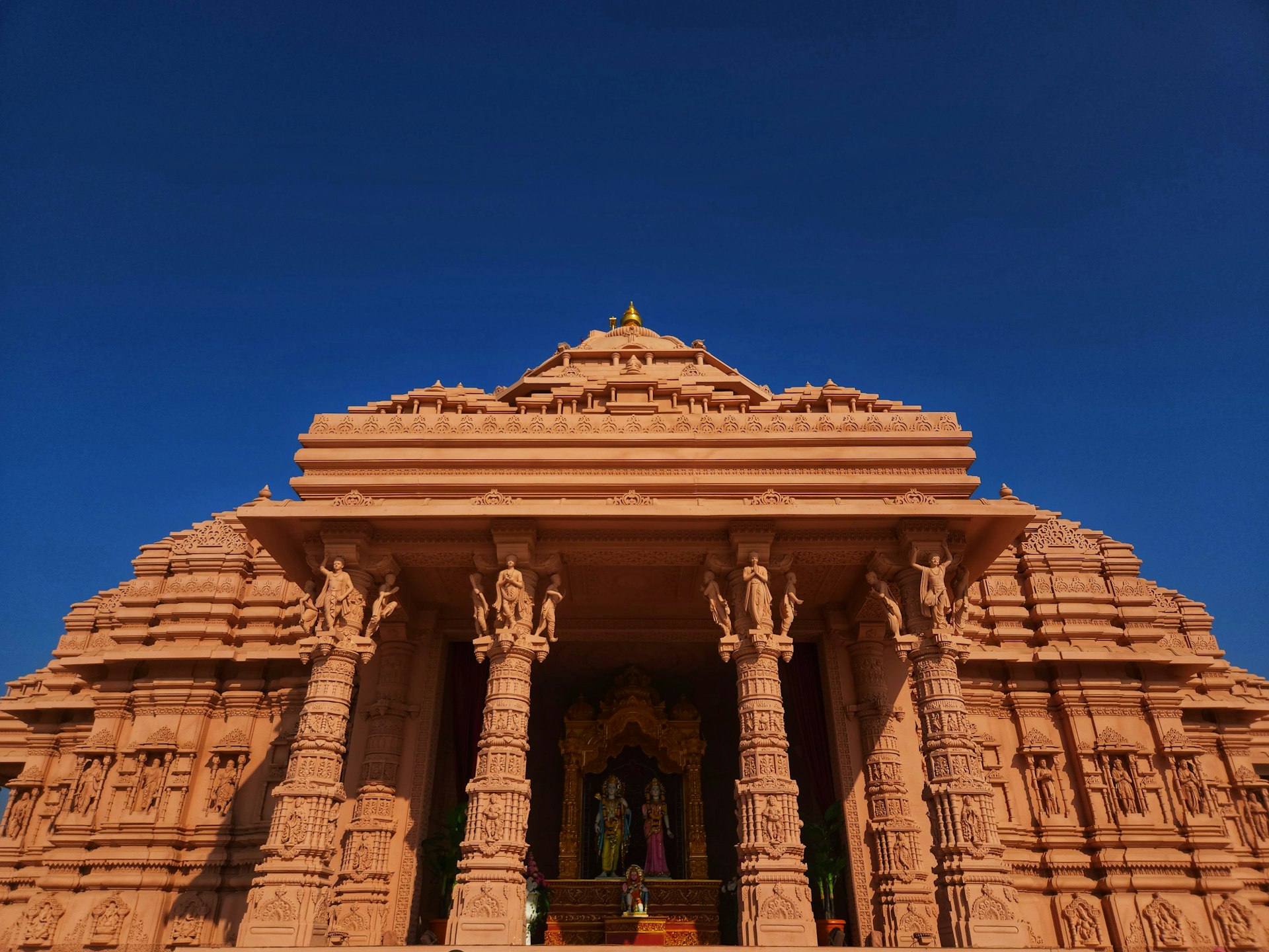 a very tall building with statues on it's sides