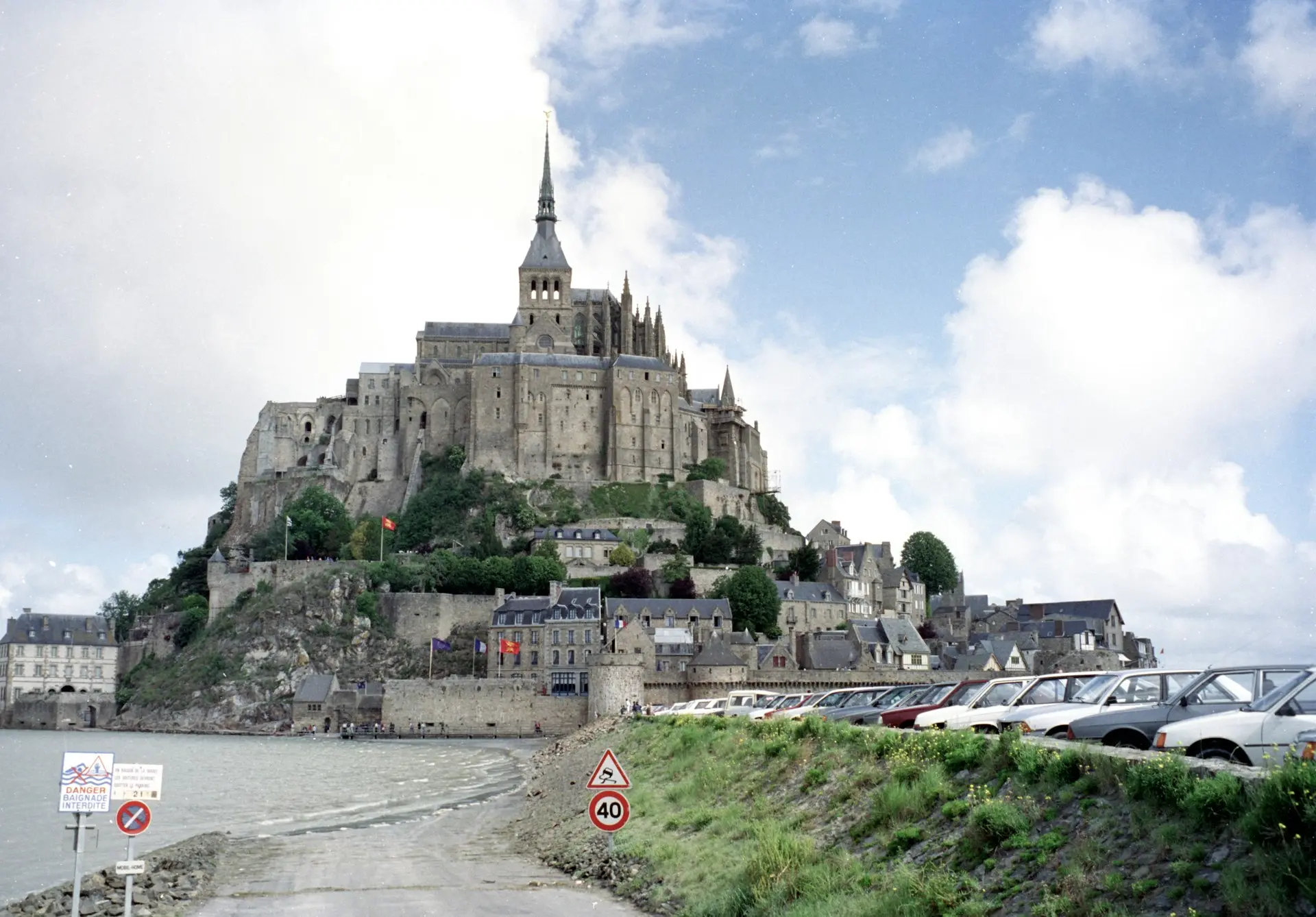 gray concrete castle near body of water during daytime