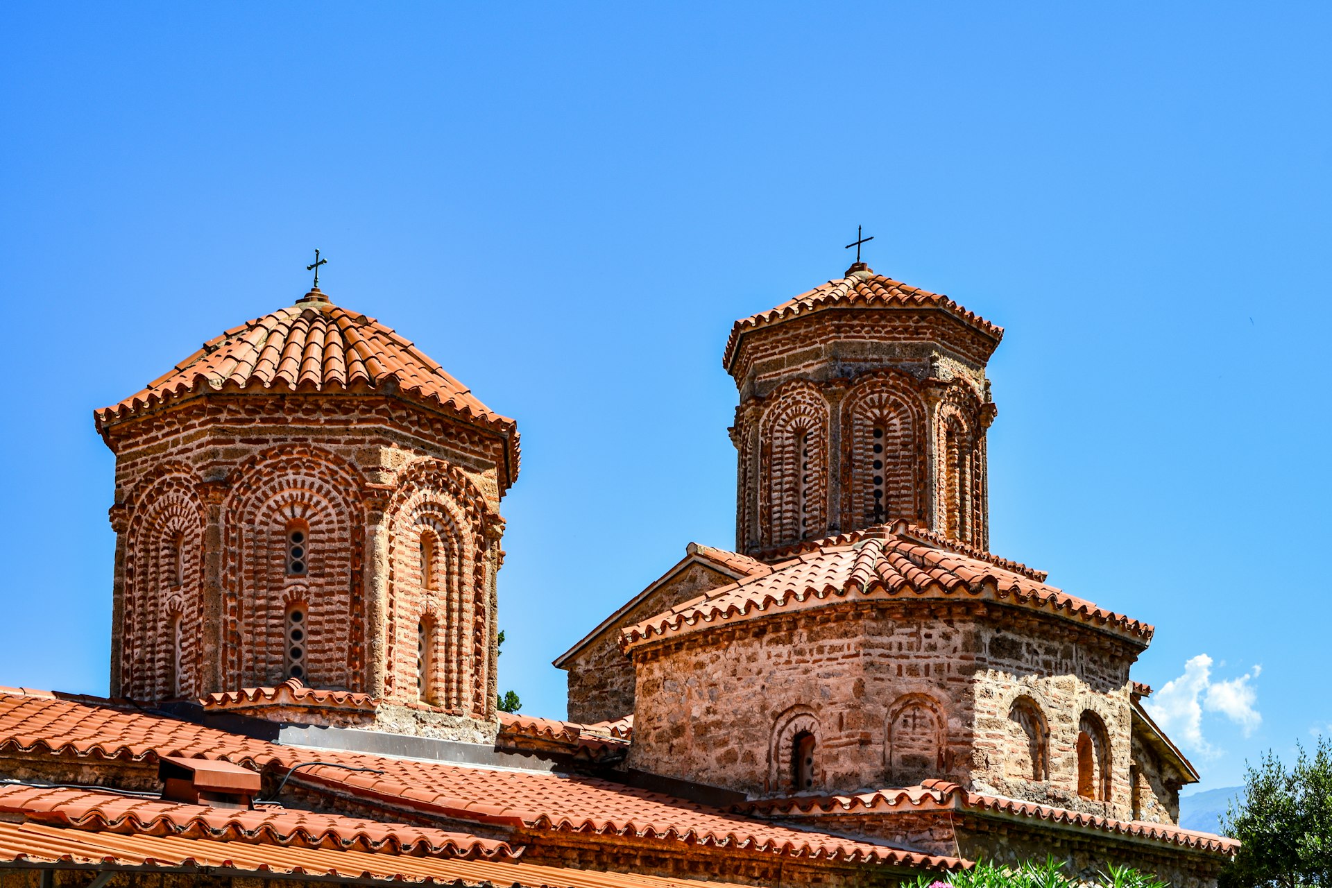 A building with two towers and a cross on top of it