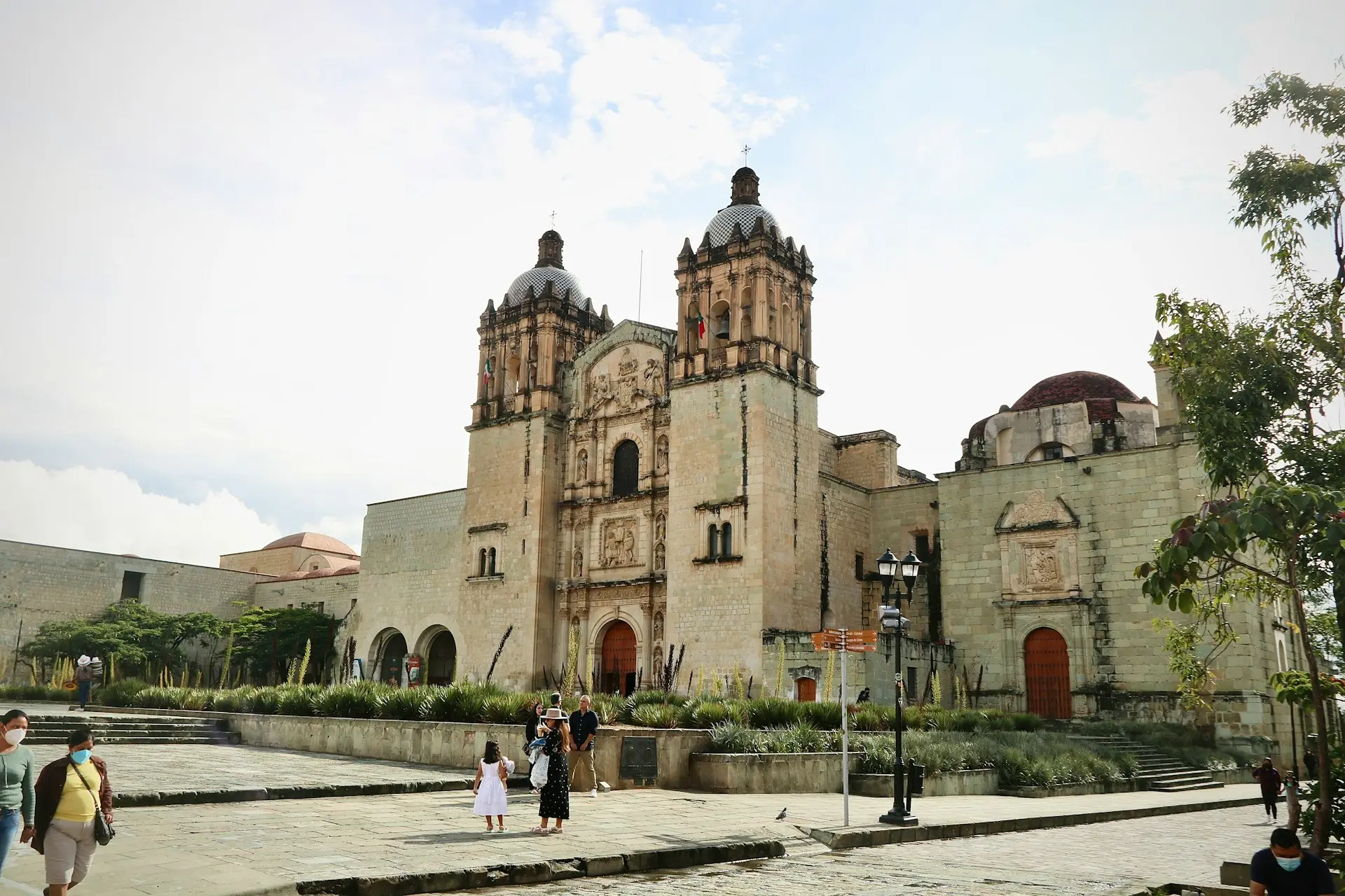 a group of people standing in front of a large building
