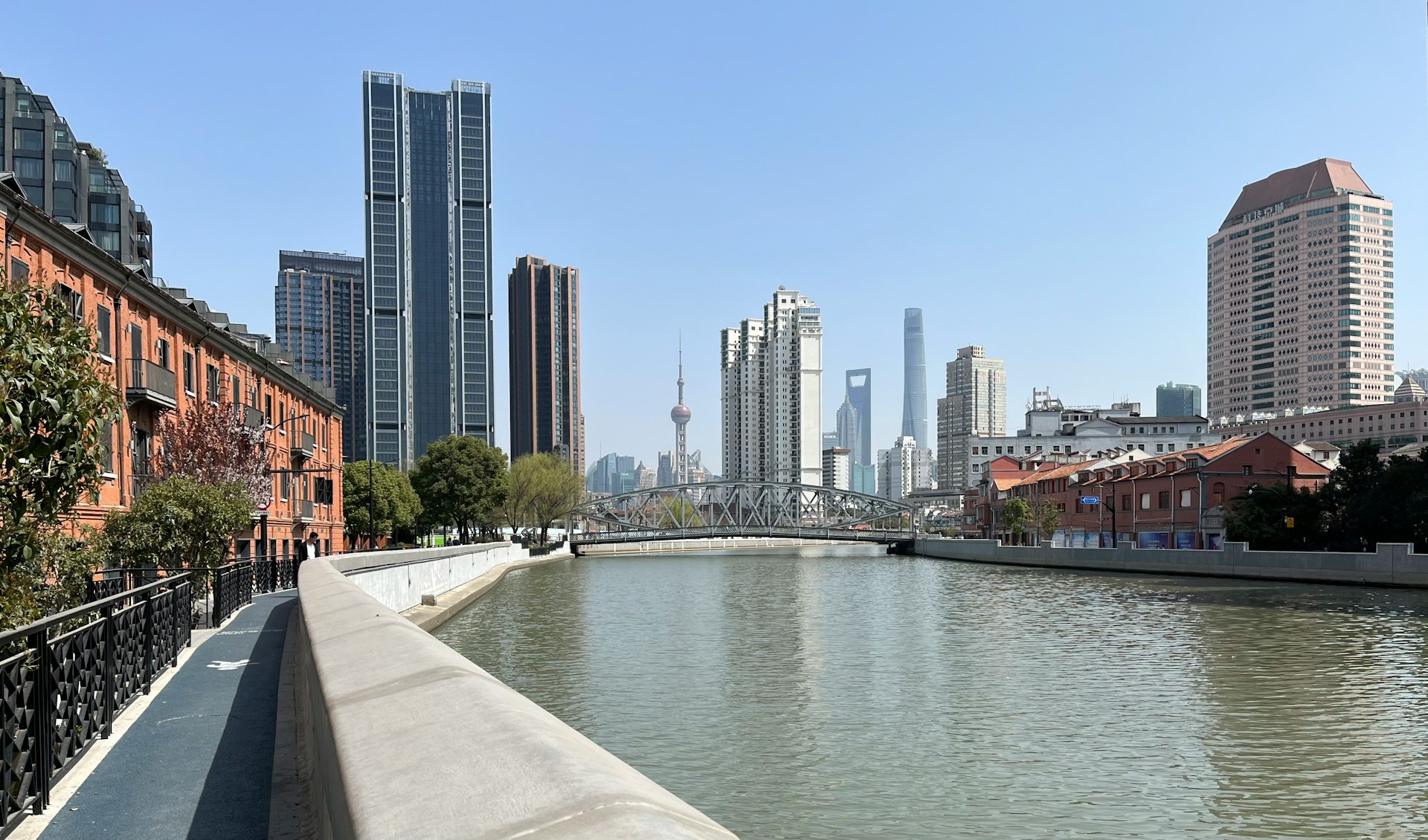 a river running through a city next to tall buildings