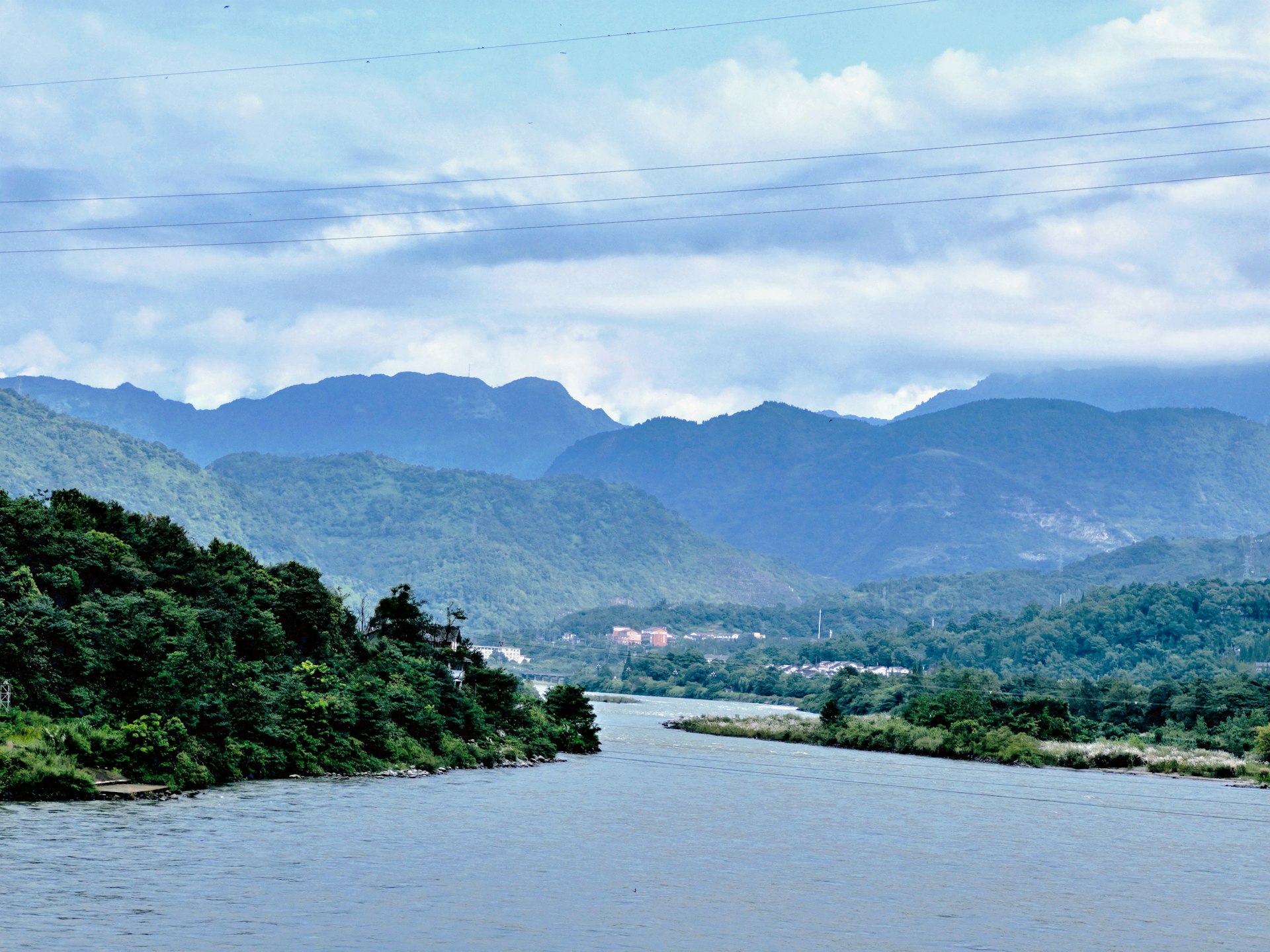 a body of water with mountains in the background
