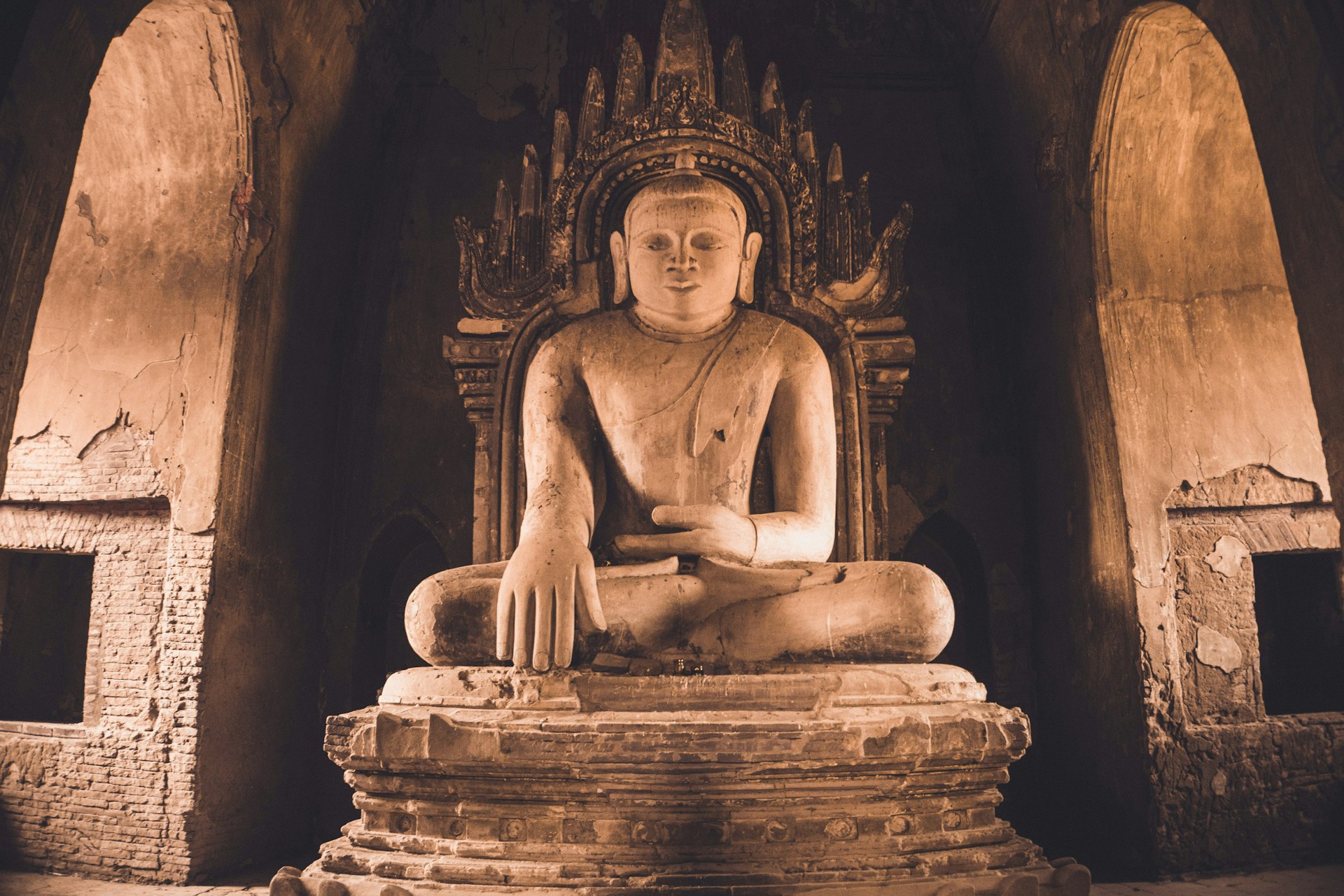woman sitting on concrete statue