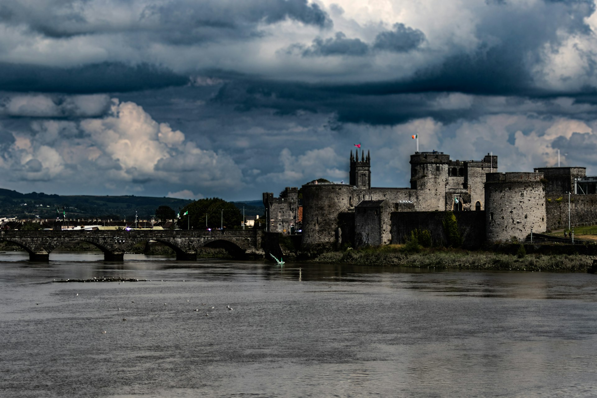a castle on a hill by a river