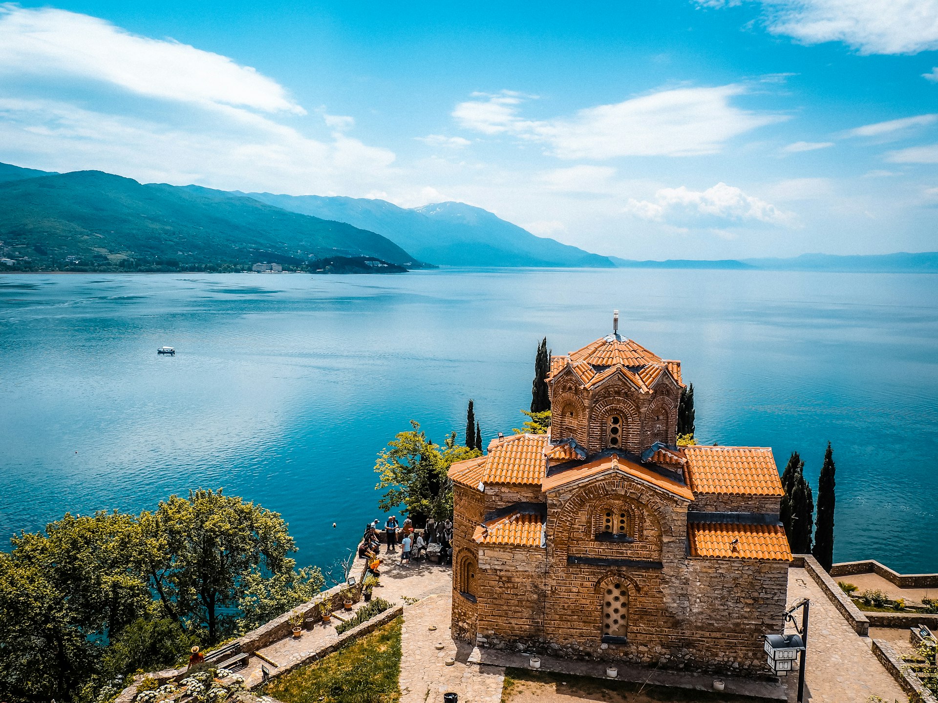 a church on a hill overlooking a body of water