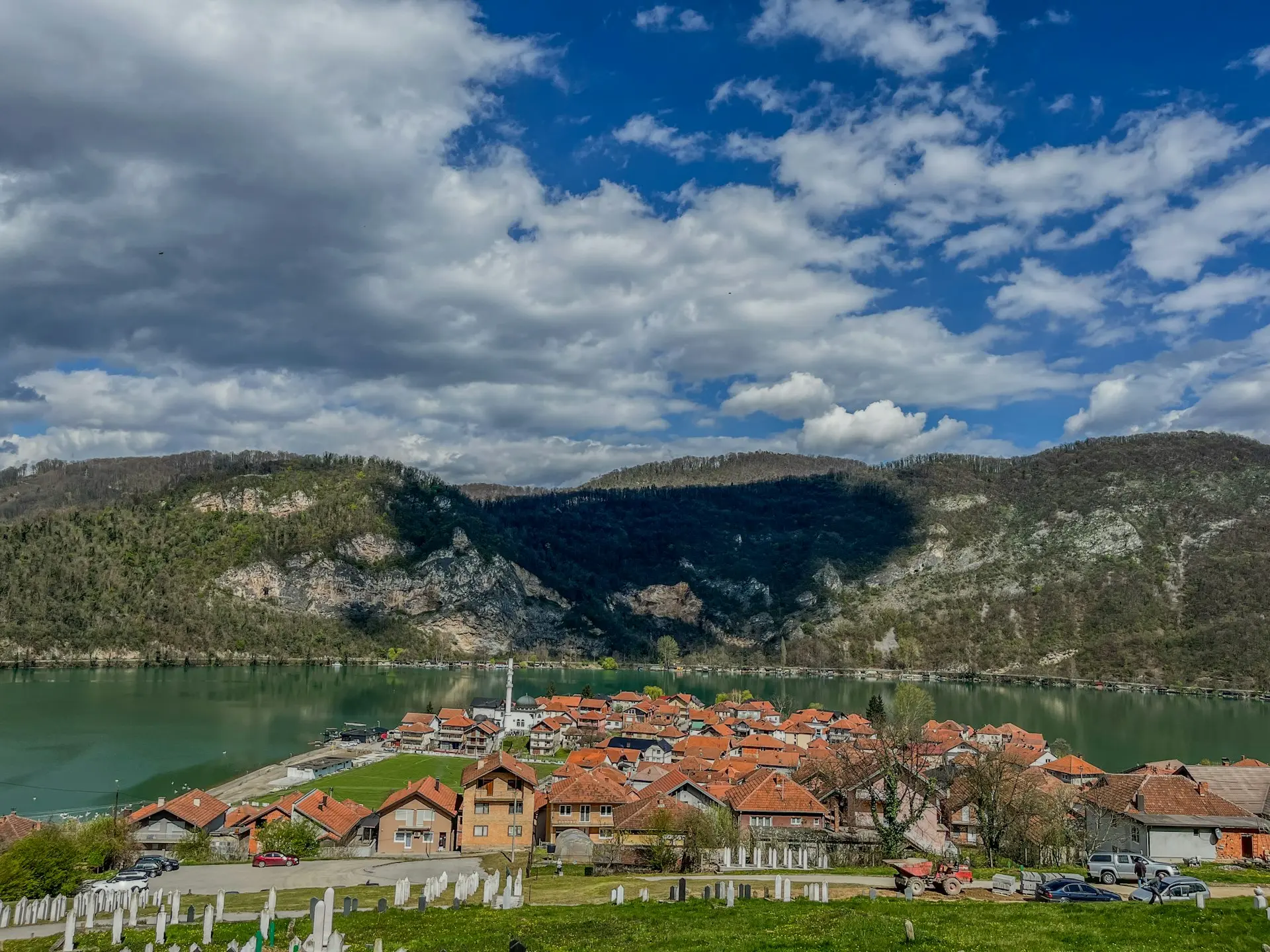 a scenic view of a village and a lake