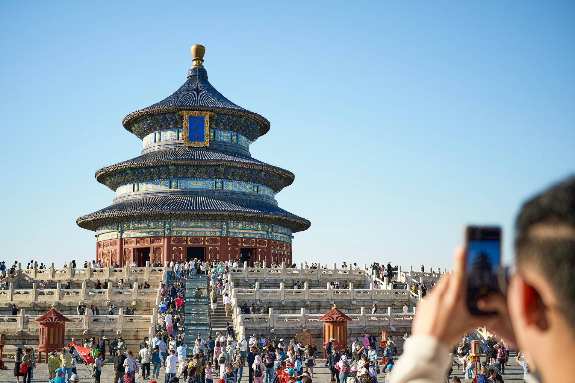 A person taking a picture of a building with a cell phone