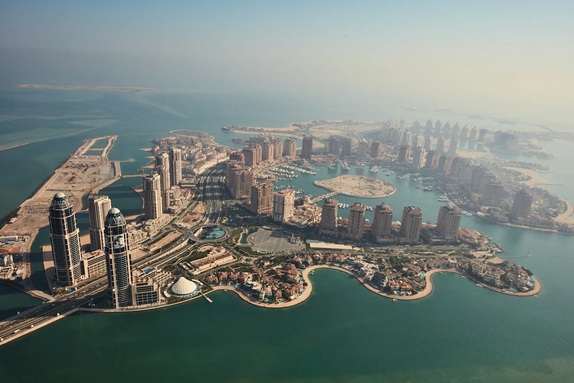 an aerial view of a city and a body of water