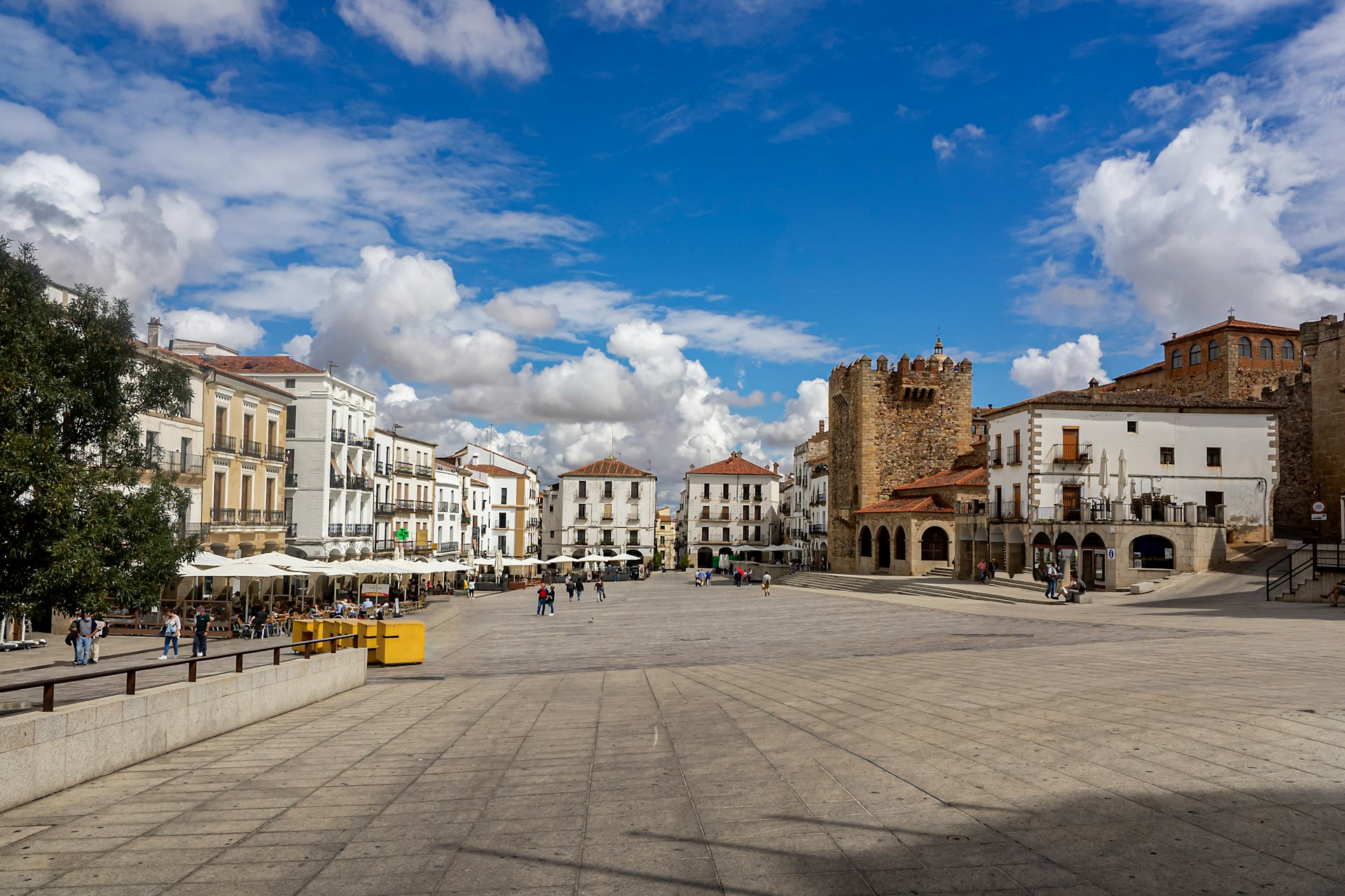 a city square with a few people walking around
