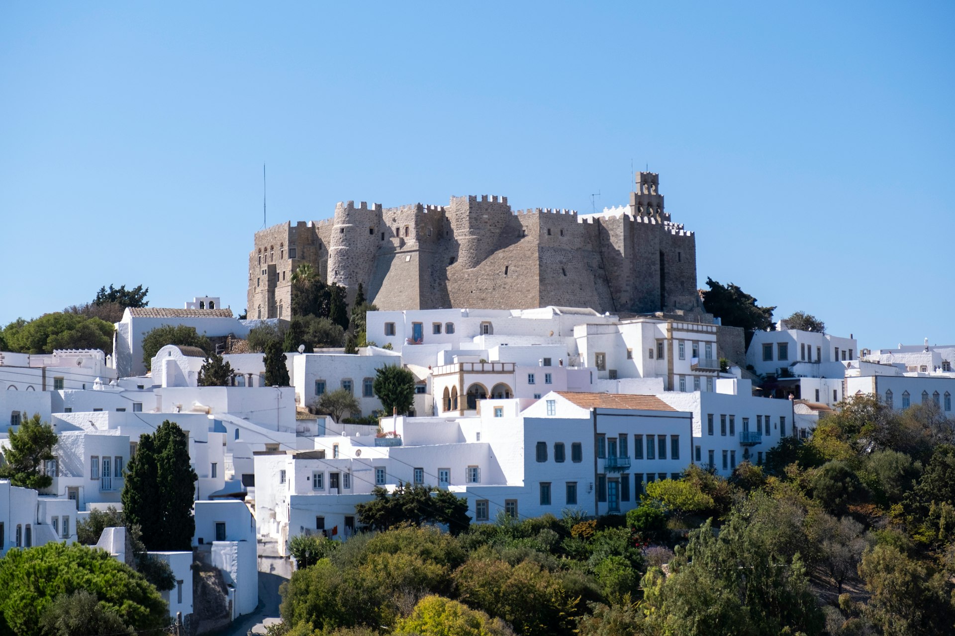 A white city with a castle on top of it