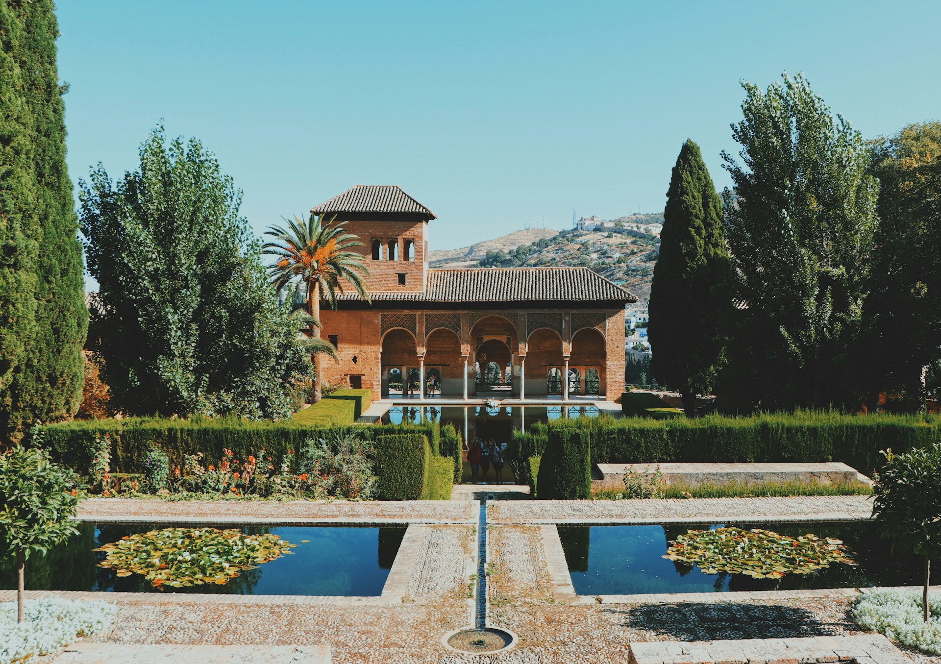 a large house with a pool in front of it