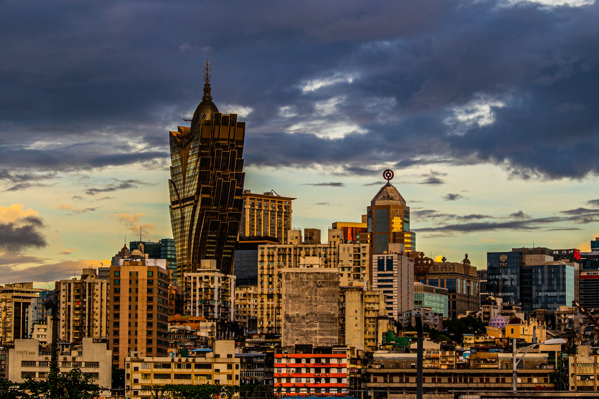 a view of a city with tall buildings under a cloudy sky