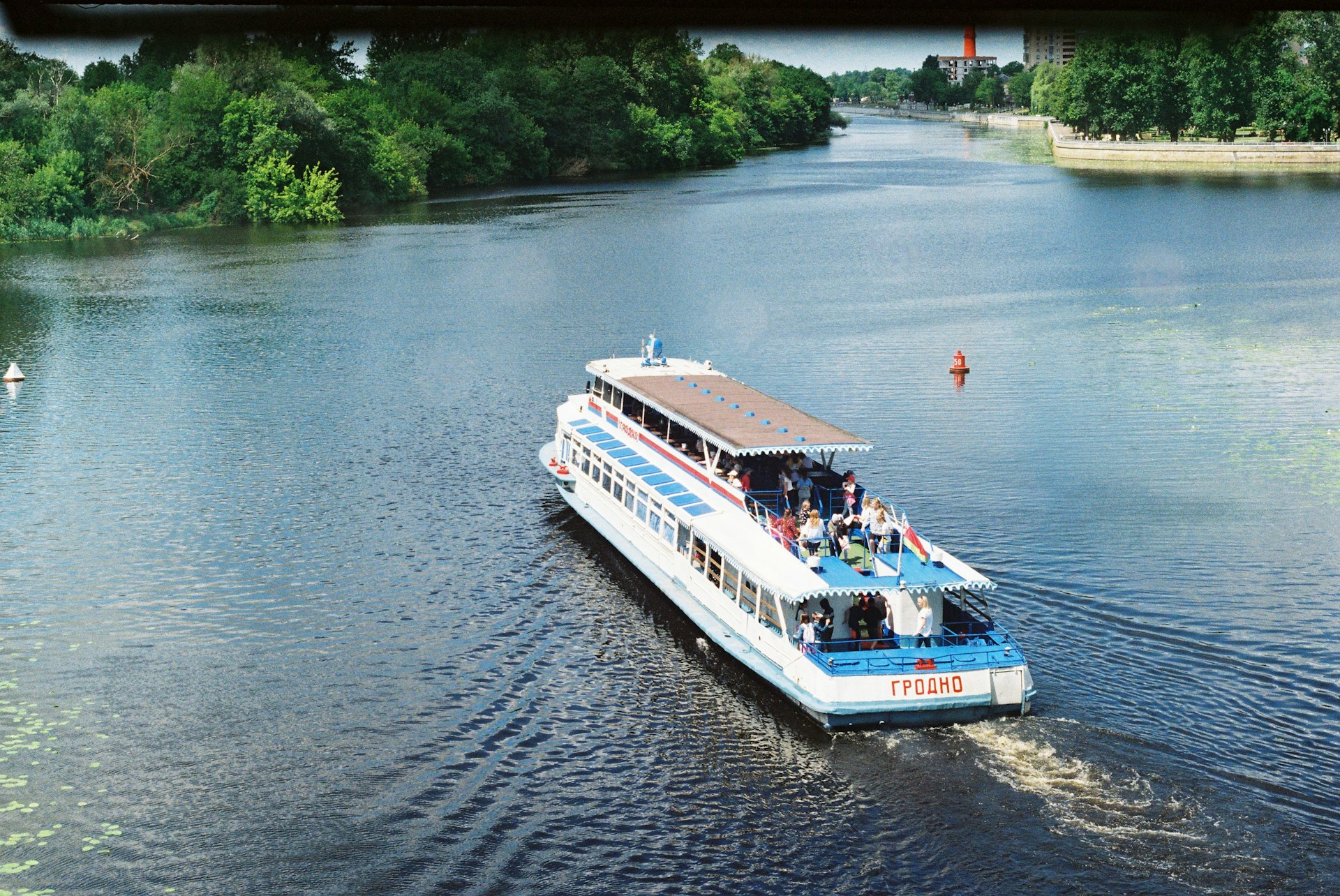 a boat is traveling down a river with people on it