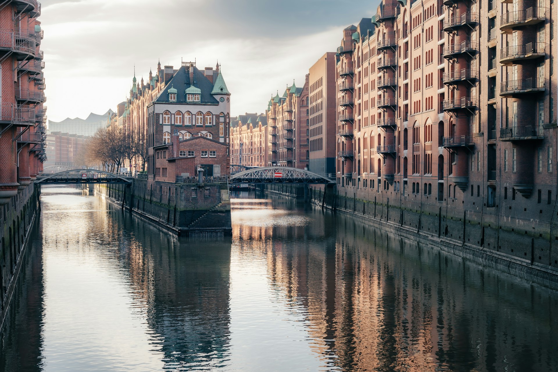 a river running through a city next to tall buildings