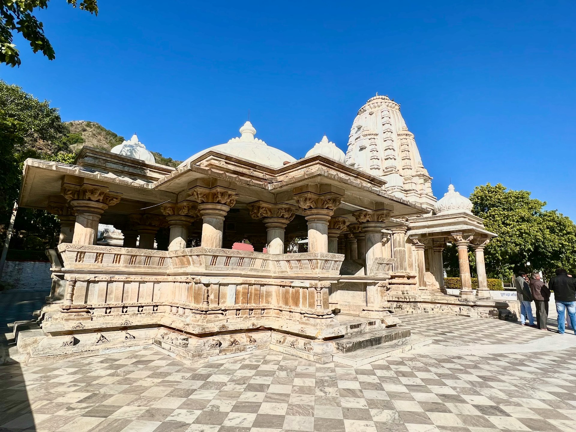 a group of people standing around a stone structure