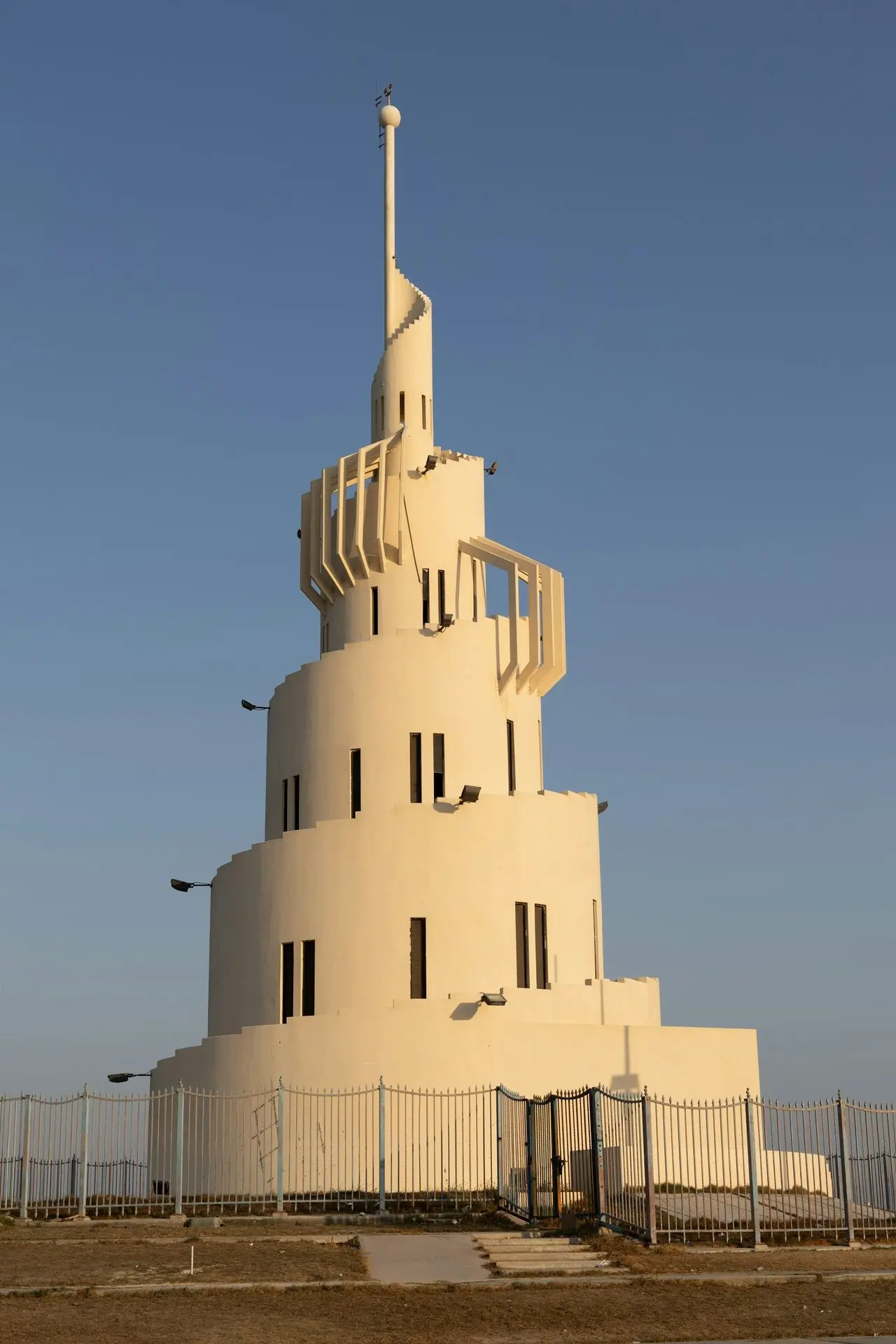 A tall white building with a cross on top of it