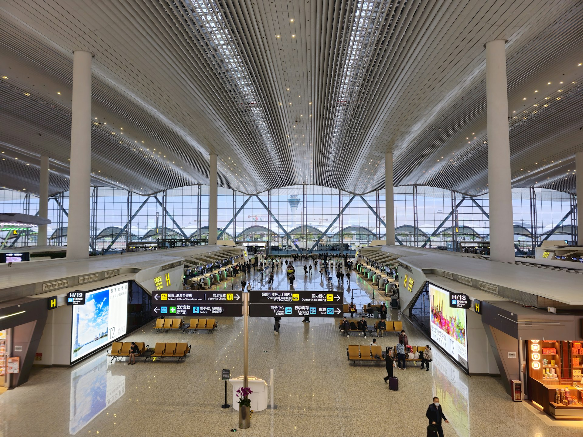 a view of an airport with people walking around
