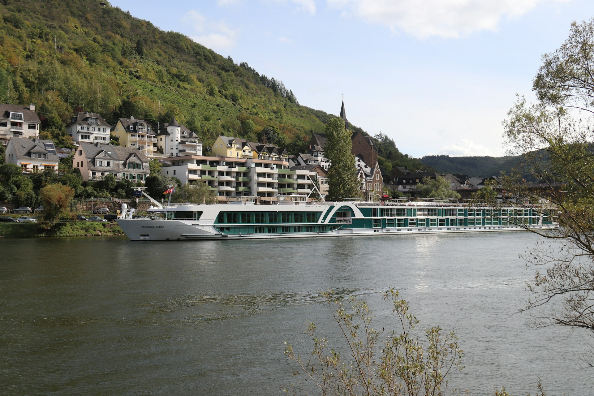 a large boat on a river near a city