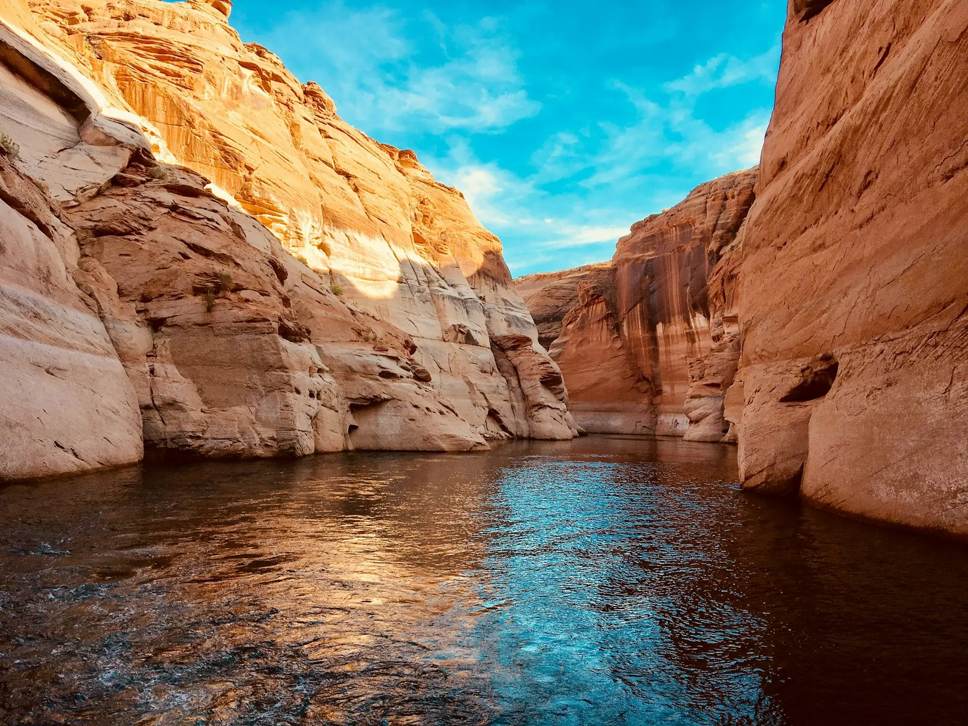 water in the middle of rock formation under blue skies