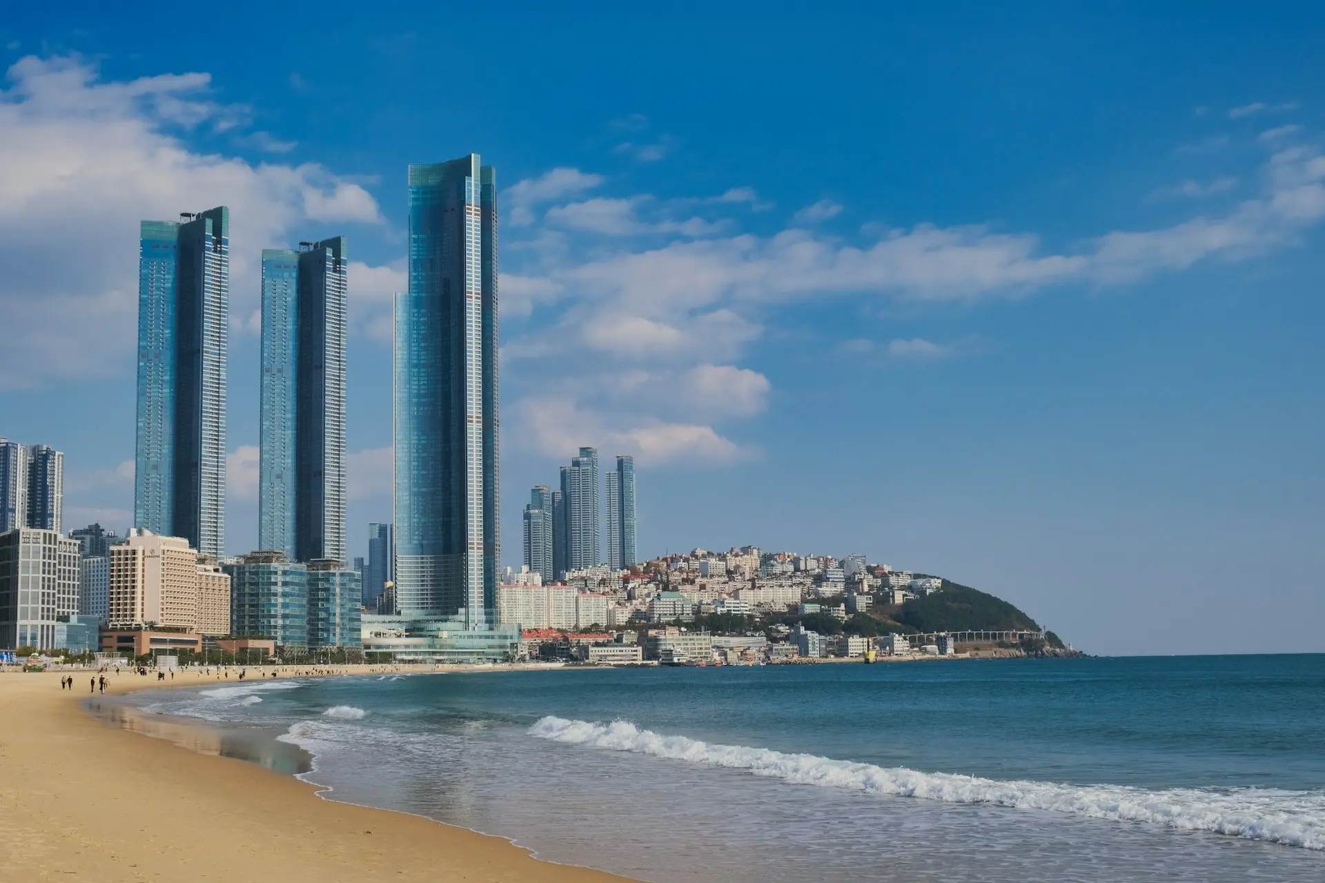 a beach with a bunch of tall buildings in the background