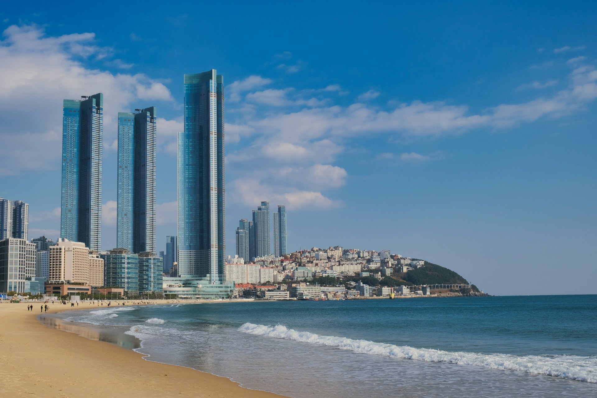a beach with a bunch of tall buildings in the background