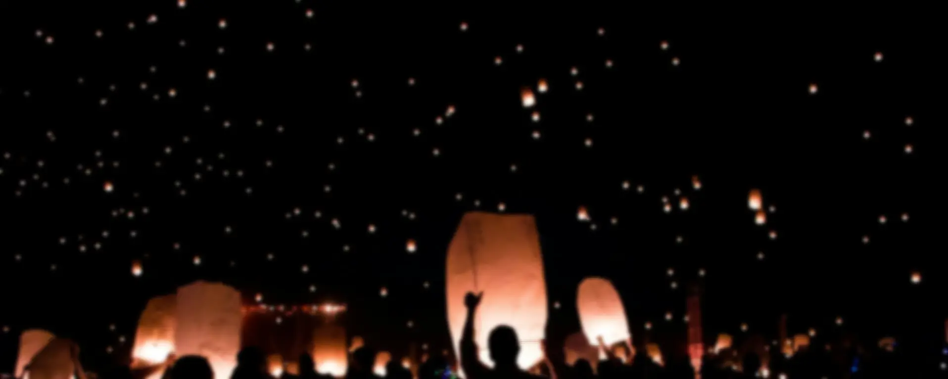 group of people holding lanterns