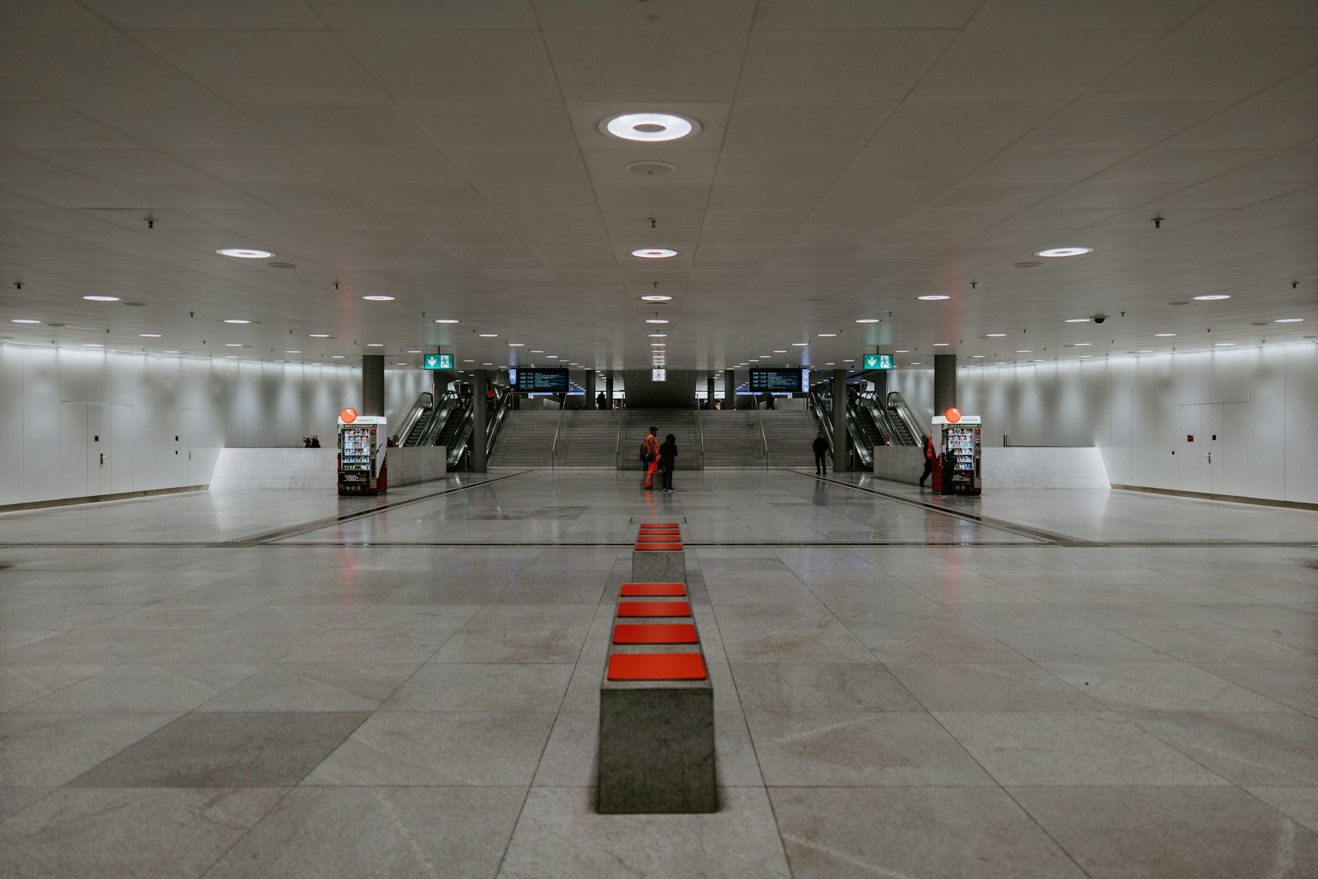 people walking on white floor tiles