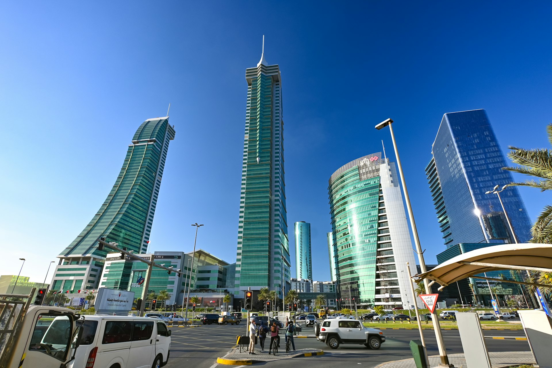 Modern skyscrapers rise against a brilliant blue sky.