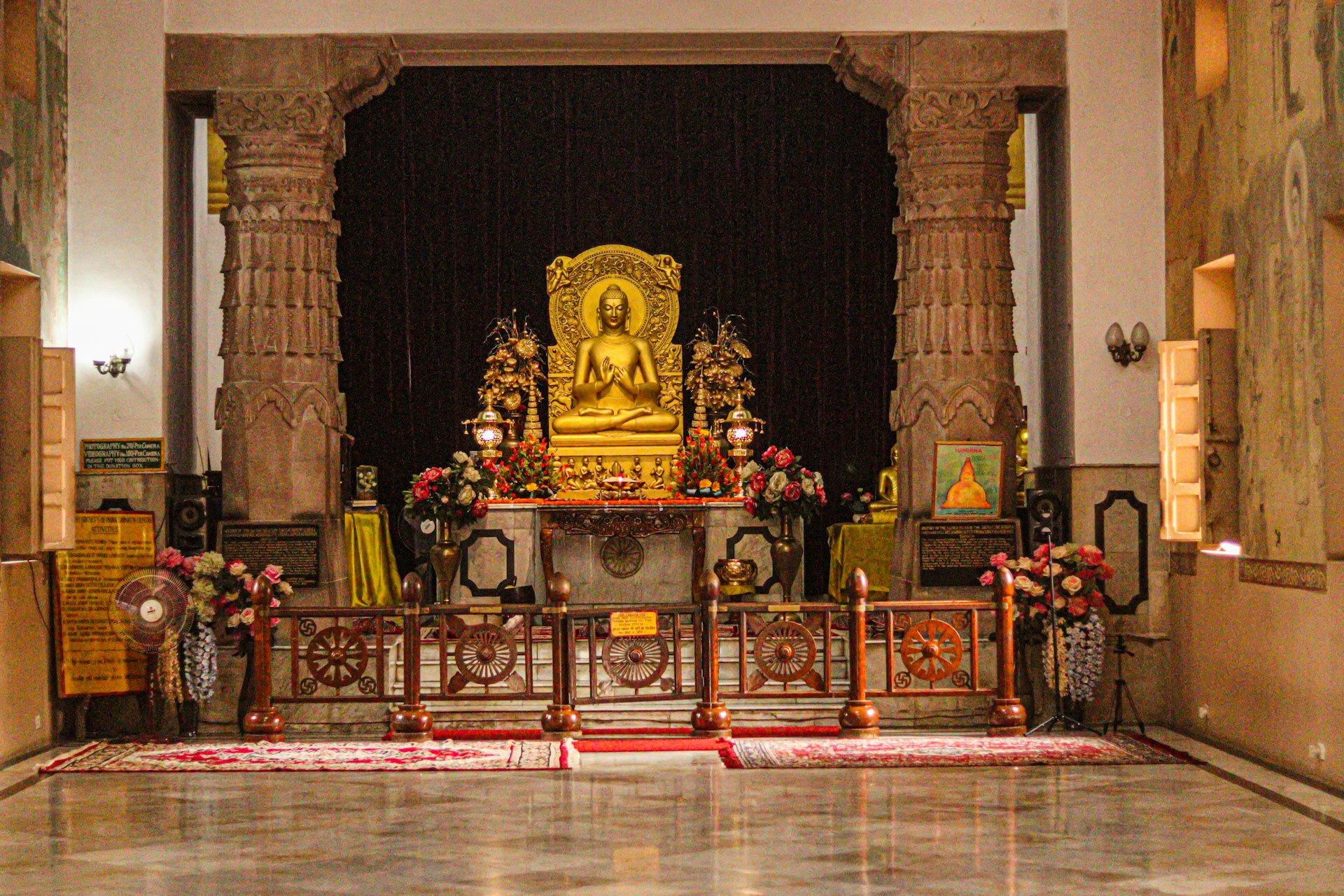 a golden buddha statue in a large room